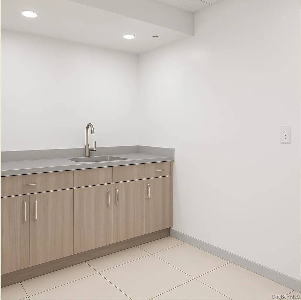 Bar area featuring light tile patterned floors, modern cabinets, recessed lighting, and light brown cabinetry Bar area featuring light tile patterned floors, modern cabinets, recessed lighting, and light brown cabinetry