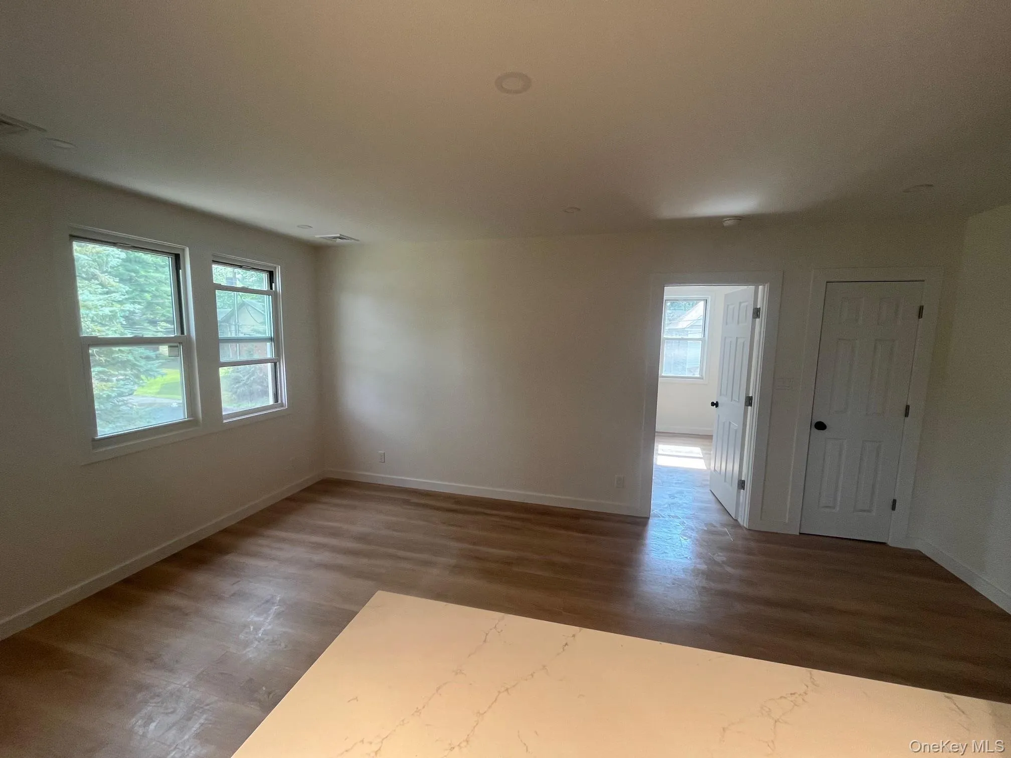 Spare room featuring dark wood finished floors Spare room featuring dark wood finished floors