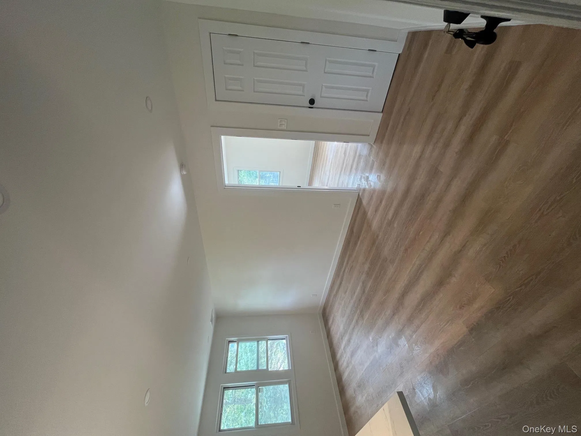 Unfurnished living room featuring wood finished floors and plenty of natural light Unfurnished living room featuring wood finished floors and plenty of natural light
