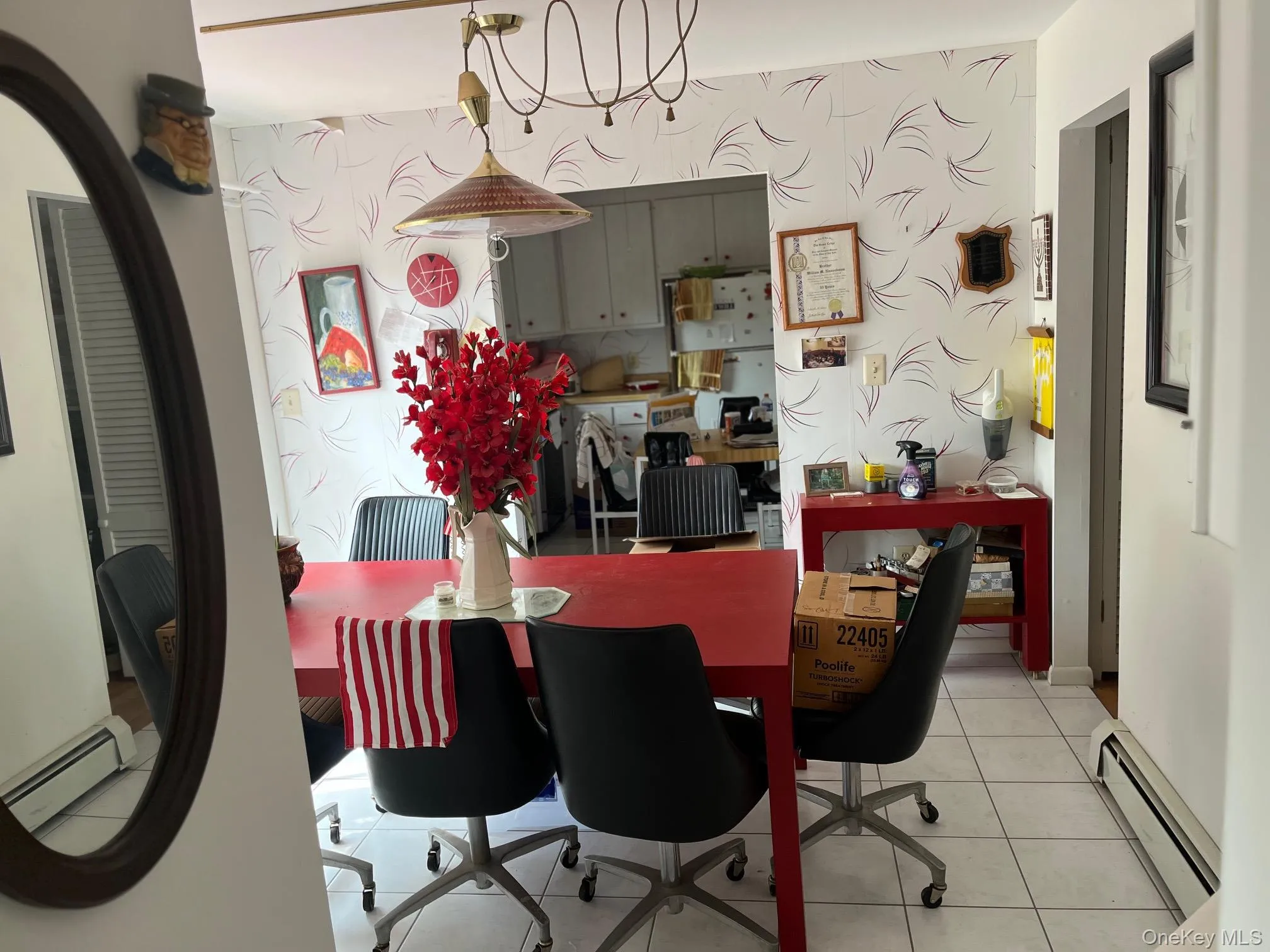 Dining area featuring wallpapered walls, a baseboard heating unit, light tile patterned floors, and baseboard heating Dining area featuring wallpapered walls, a baseboard heating unit, light tile patterned floors, and baseboard heating