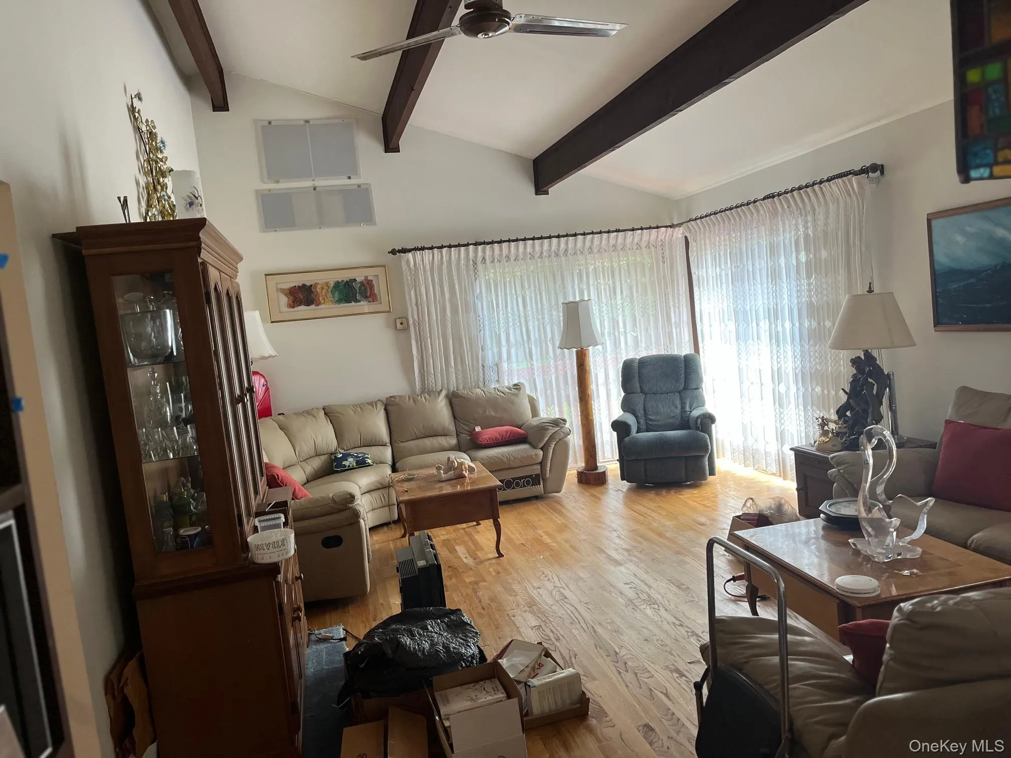 Living area with a ceiling fan and light wood finished floors Living area with a ceiling fan and light wood finished floors