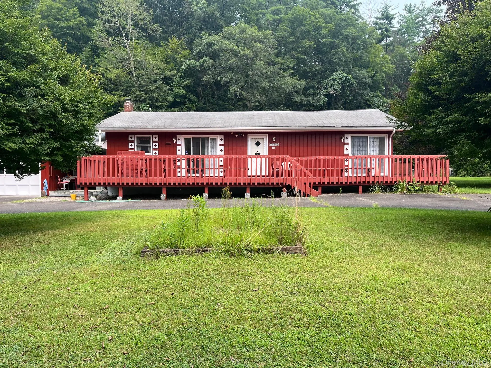 View of front of home featuring a chimney, a front lawn, and a porch View of front of home featuring a chimney, a front lawn, and a porch