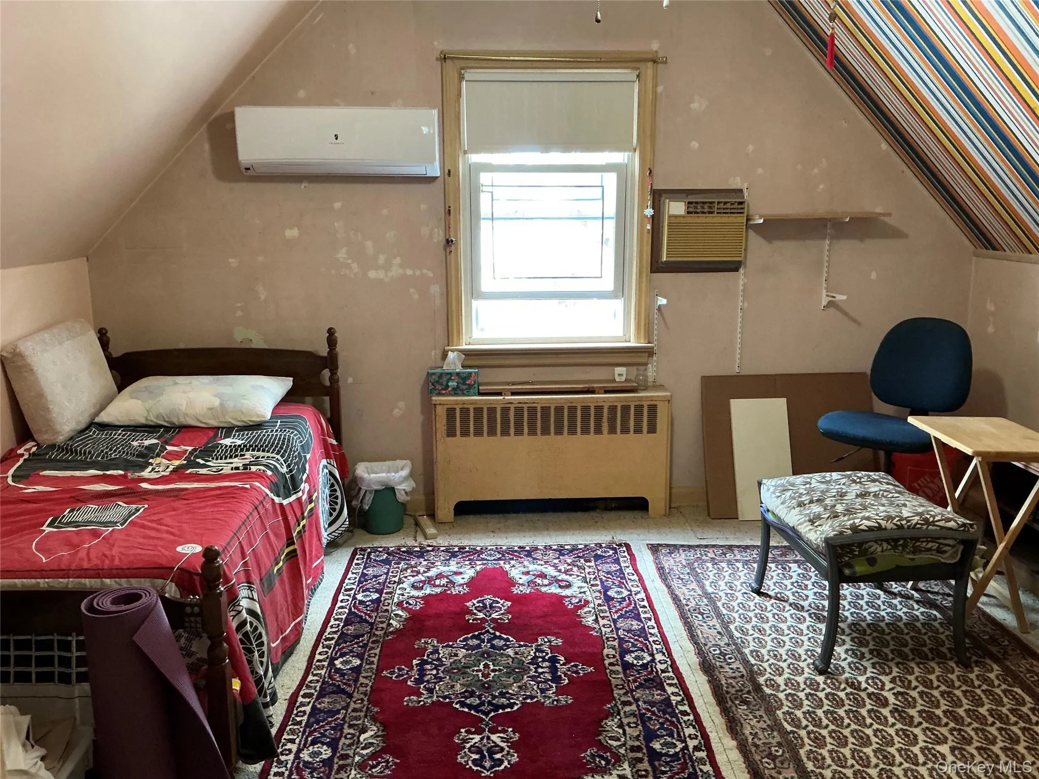 Bedroom with radiator, a wall mounted air conditioner, and a wall mounted AC Bedroom with radiator, a wall mounted air conditioner, and a wall mounted AC