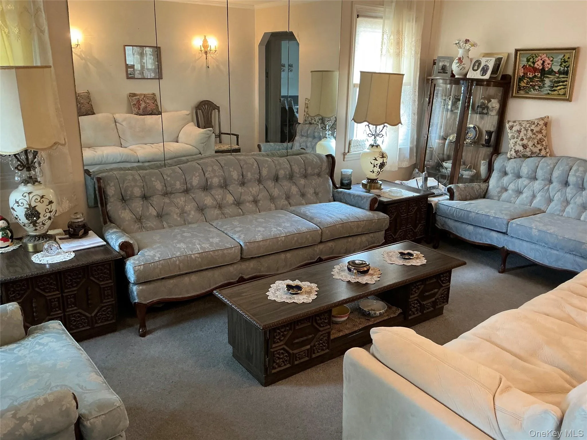 Carpeted living area with arched walkways Carpeted living area with arched walkways