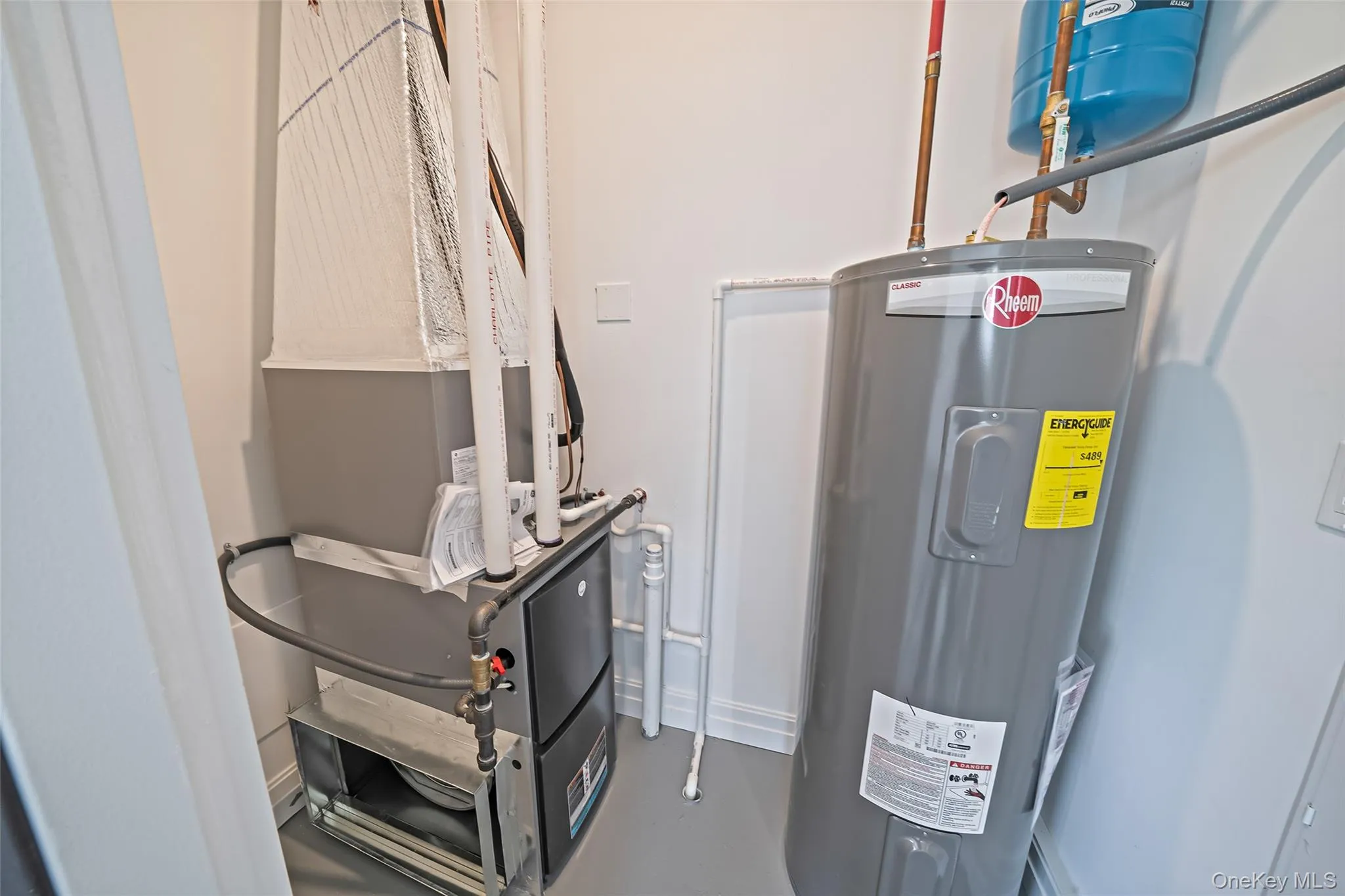 Utilities featuring electric water heater and heating unit Utilities featuring electric water heater and heating unit