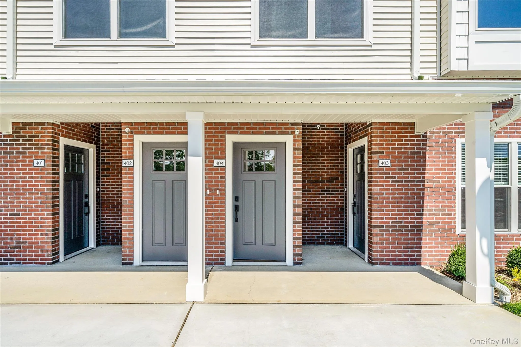 Property entrance with a porch and brick siding Property entrance with a porch and brick siding