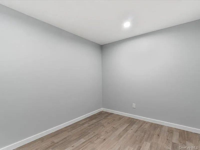 Unfurnished room with light wood-type flooring and recessed lighting Unfurnished room with light wood-type flooring and recessed lighting