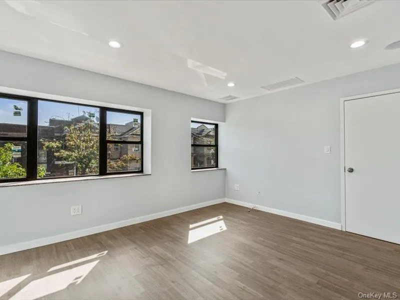 Unfurnished room with wood finished floors and recessed lighting Unfurnished room with wood finished floors and recessed lighting