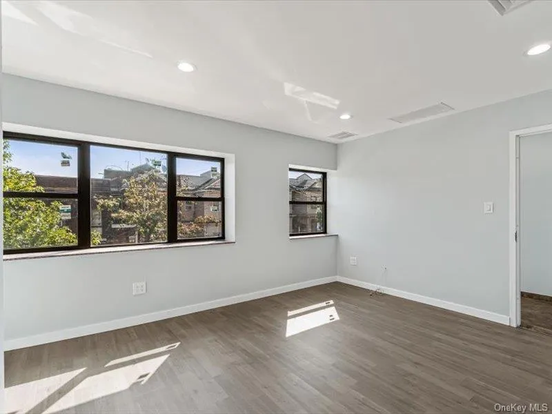 Empty room with dark wood finished floors and recessed lighting Empty room with dark wood finished floors and recessed lighting