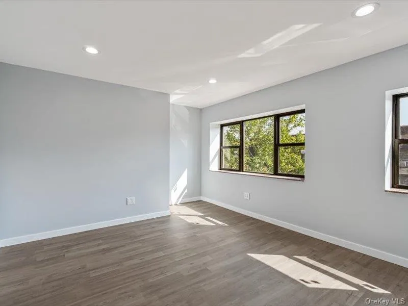 Empty room featuring recessed lighting and dark wood finished floors Empty room featuring recessed lighting and dark wood finished floors