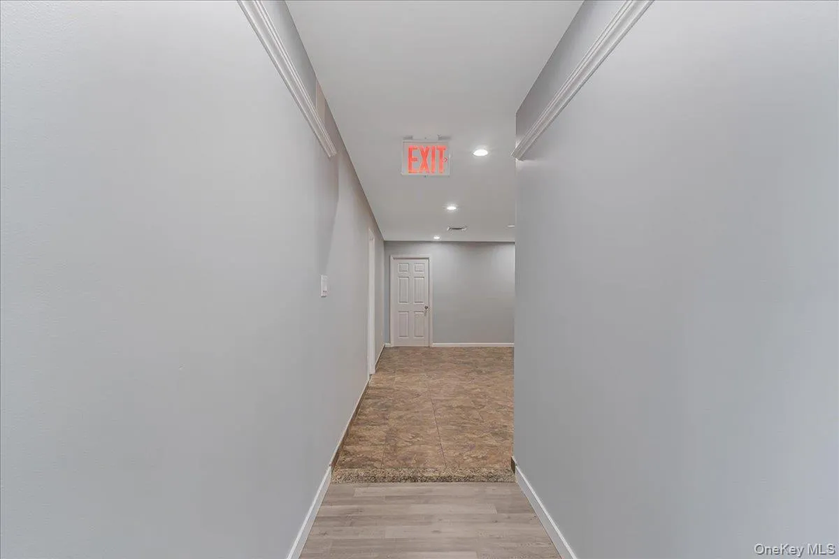 Hall with recessed lighting and light wood-style floors Hall with recessed lighting and light wood-style floors