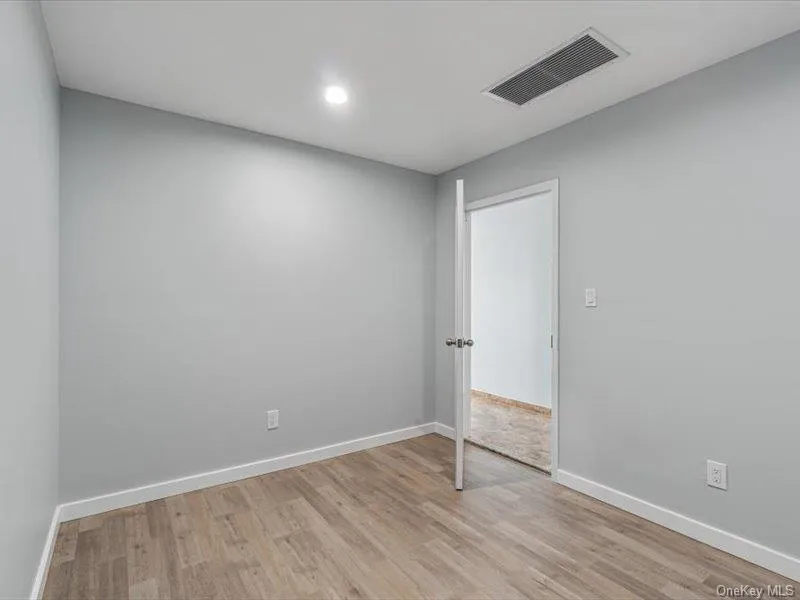 Empty room featuring light wood finished floors and recessed lighting Empty room featuring light wood finished floors and recessed lighting