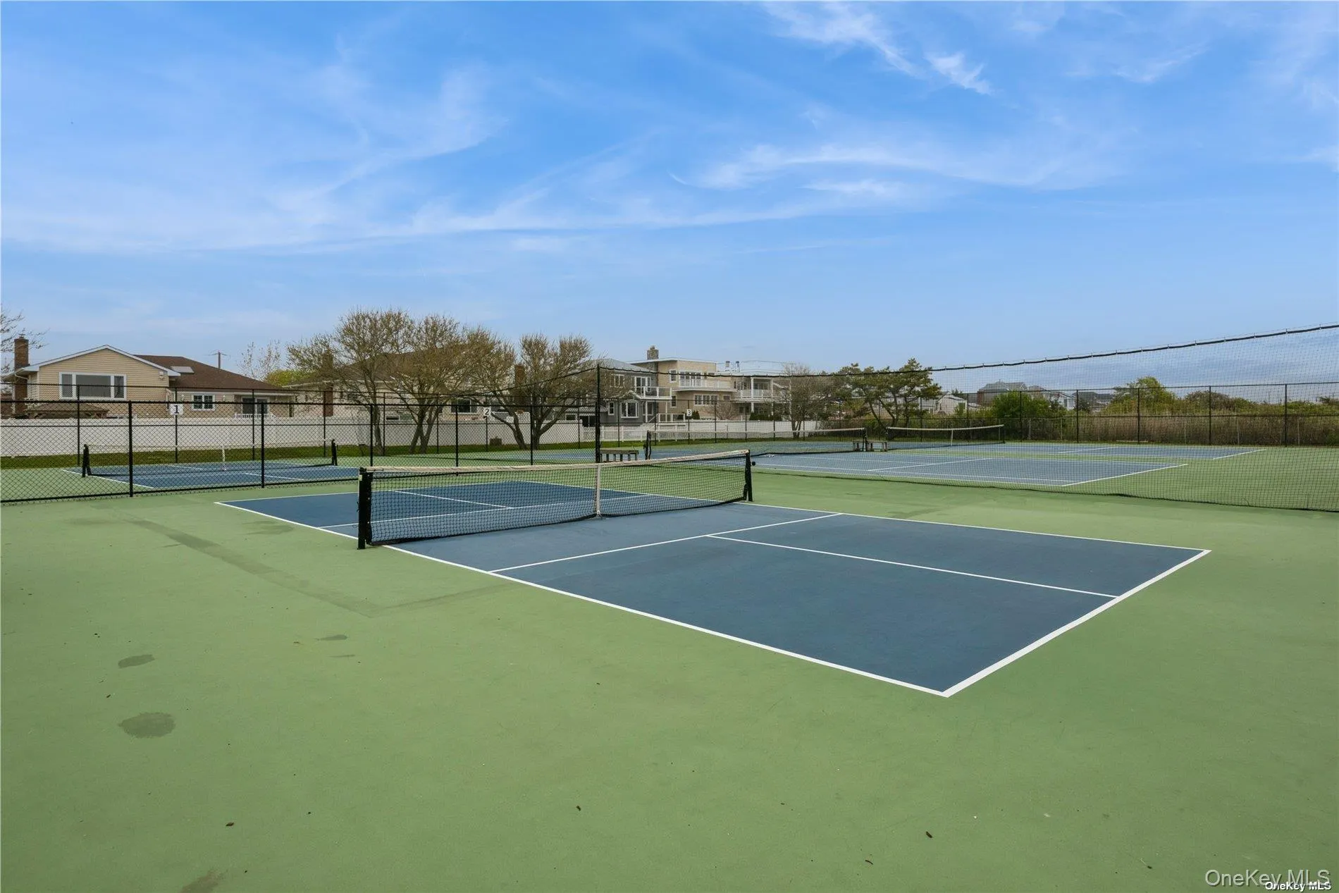 View of tennis court with community basketball court and a residential view View of tennis court with community basketball court and a residential view