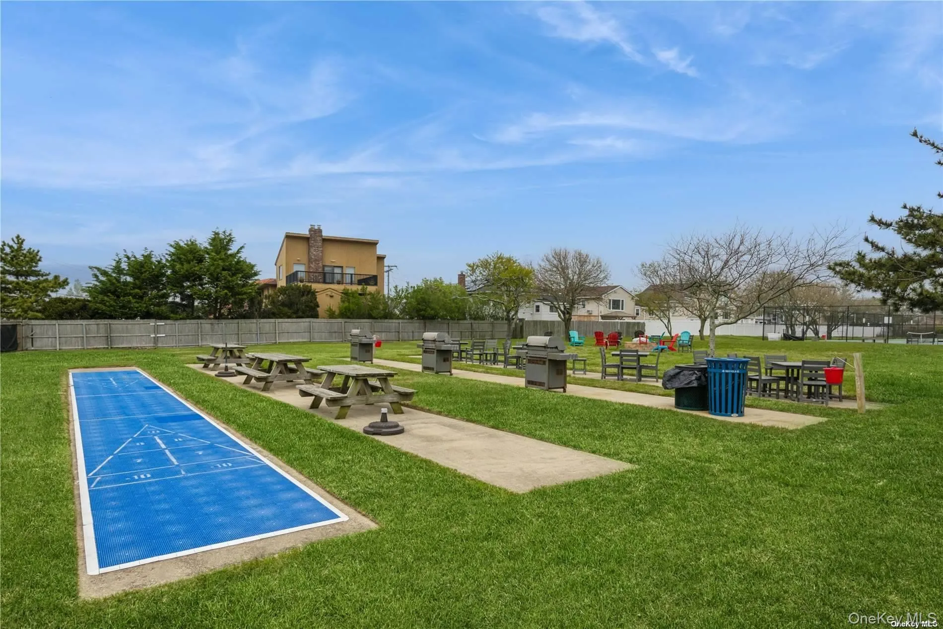 View of property's community featuring shuffleboard and a patio area View of property's community featuring shuffleboard and a patio area