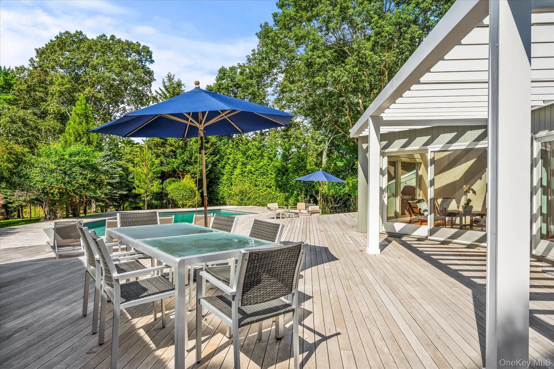 Wooden terrace featuring outdoor dining area and pergola Wooden terrace featuring outdoor dining area and pergola
