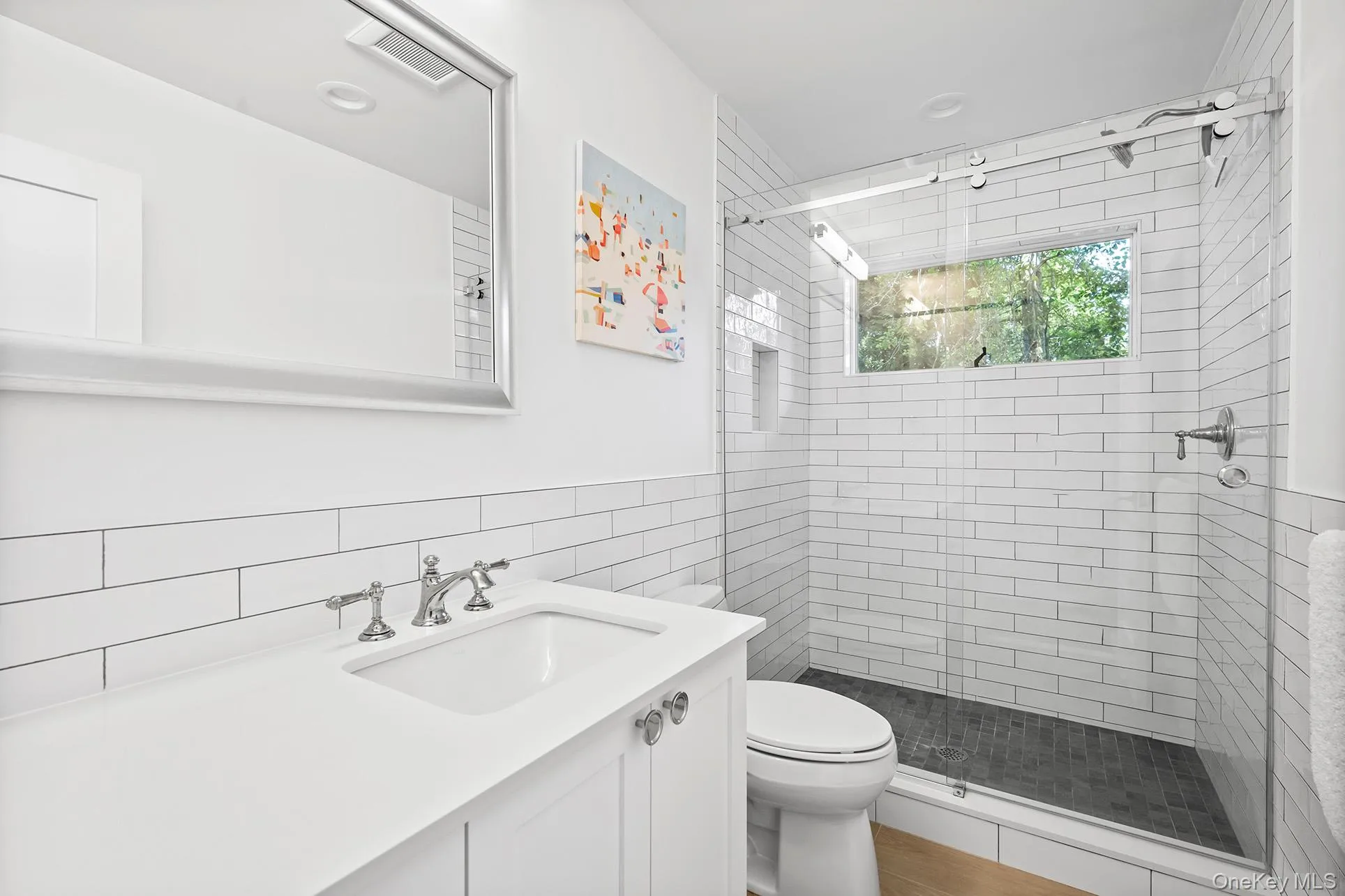 Full bath featuring vanity, a shower stall, and tile walls Full bath featuring vanity, a shower stall, and tile walls