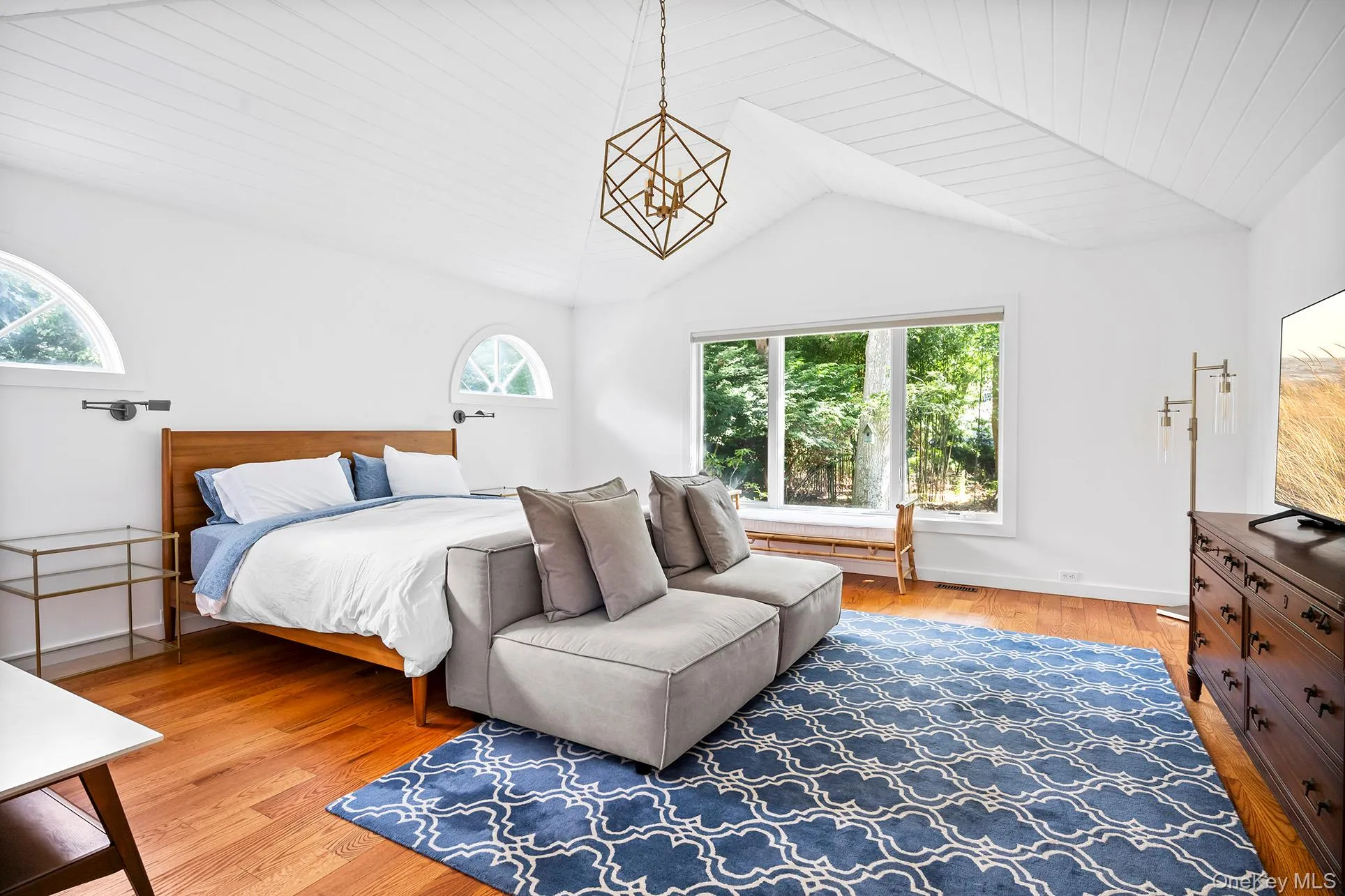Primary bedroom with lofted ceiling, light wood finished floors, wooden ceiling, and a chandelier Primary bedroom with lofted ceiling, light wood finished floors, wooden ceiling, and a chandelier