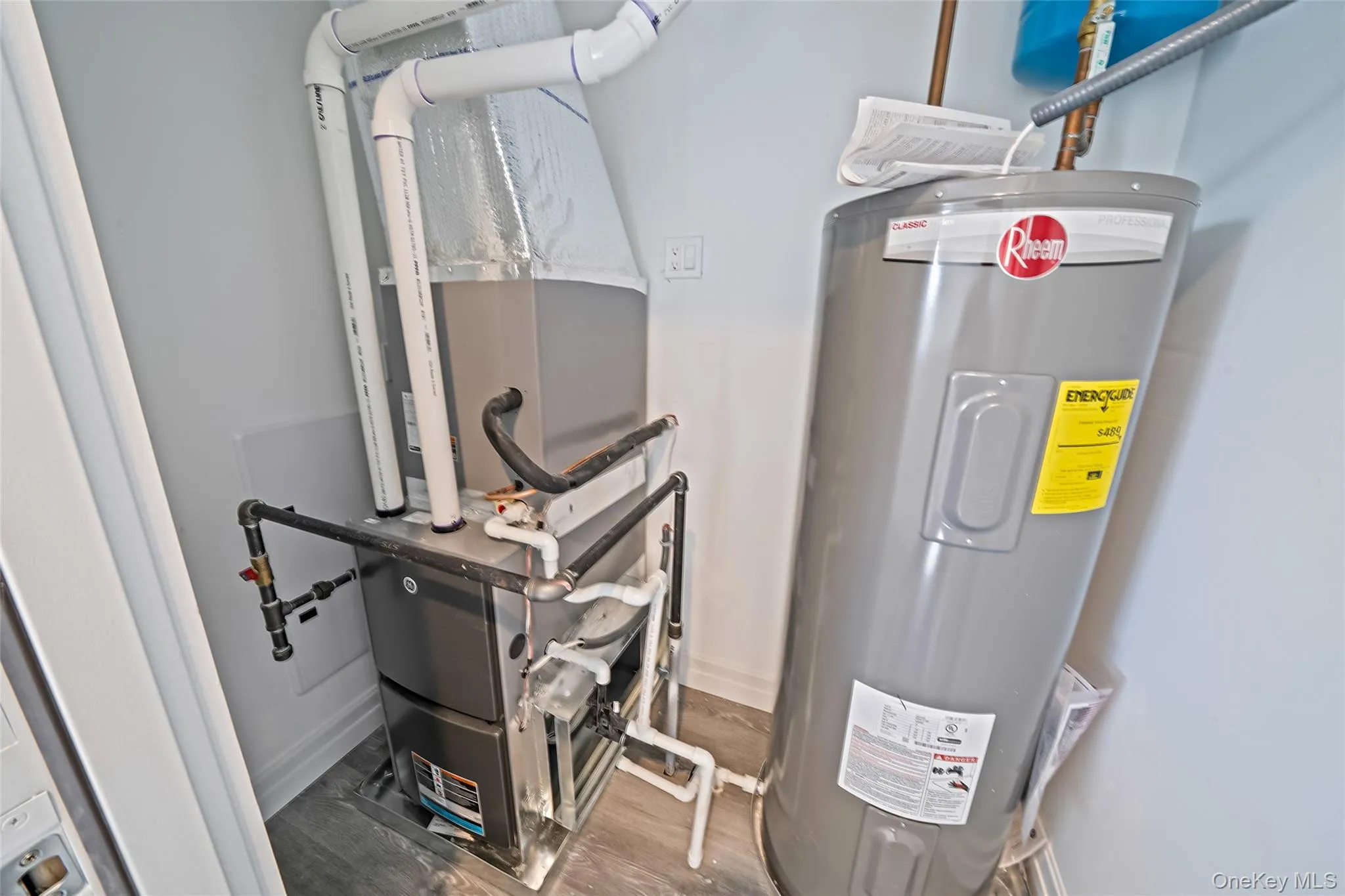 Utilities featuring water heater and heating unit Utilities featuring water heater and heating unit