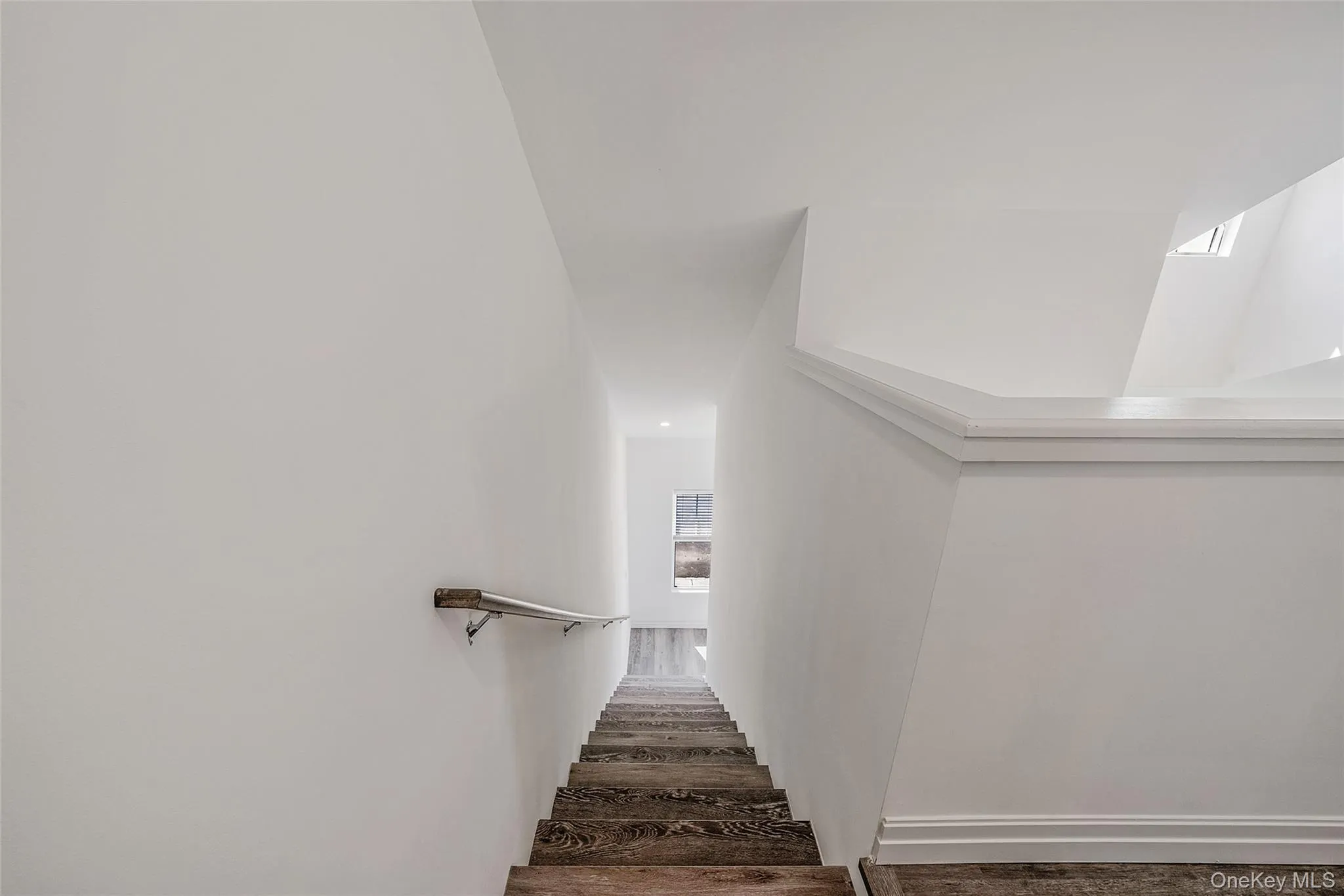 Stairs featuring wood finished floors Stairs featuring wood finished floors