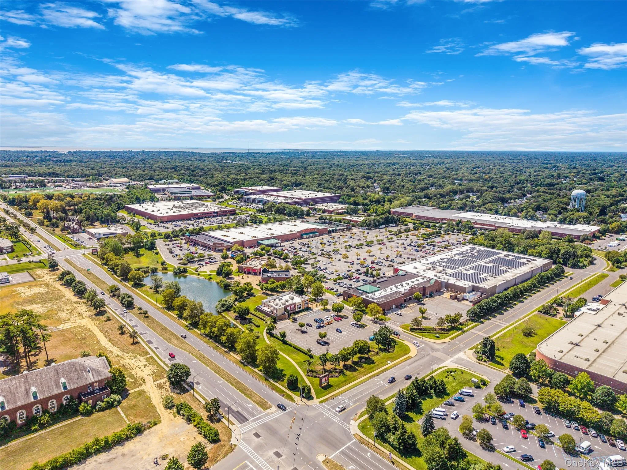 Drone / aerial view of a commercial area and a tree filled landscape Drone / aerial view of a commercial area and a tree filled landscape