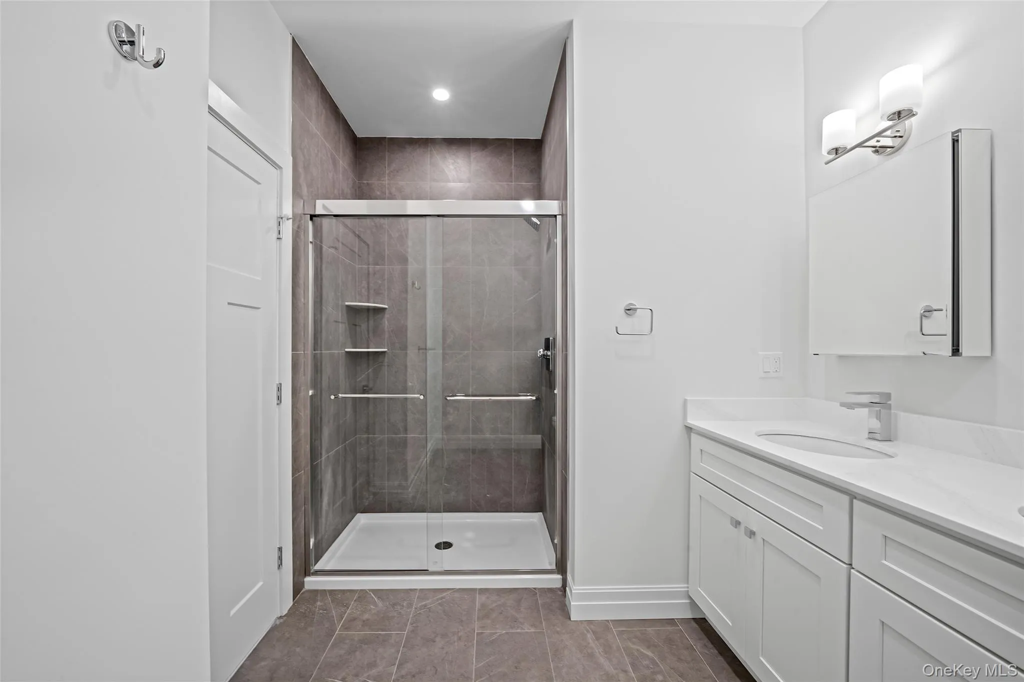Full bath with double vanity, a stall shower, and recessed lighting Full bath with double vanity, a stall shower, and recessed lighting