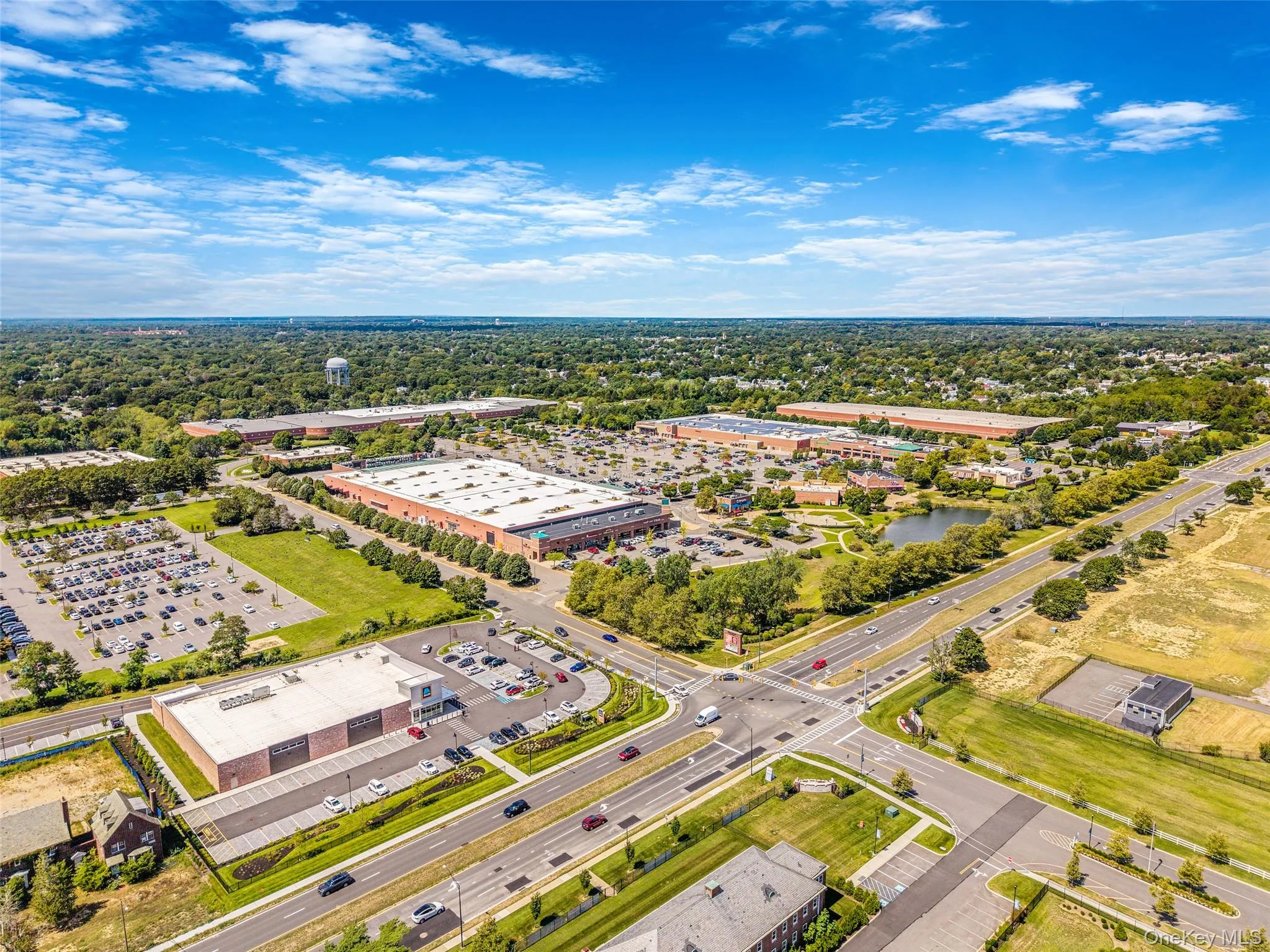 Bird's eye view of a tree filled landscape and a commercial area Bird's eye view of a tree filled landscape and a commercial area
