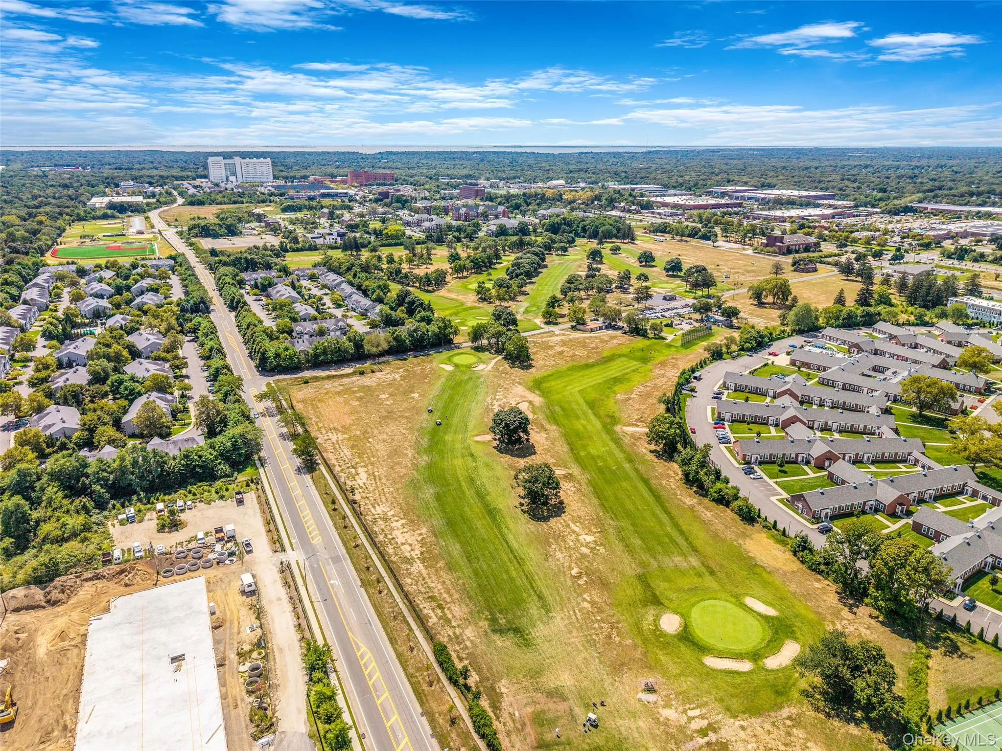 Aerial perspective of suburban area featuring a local golf course Aerial perspective of suburban area featuring a local golf course