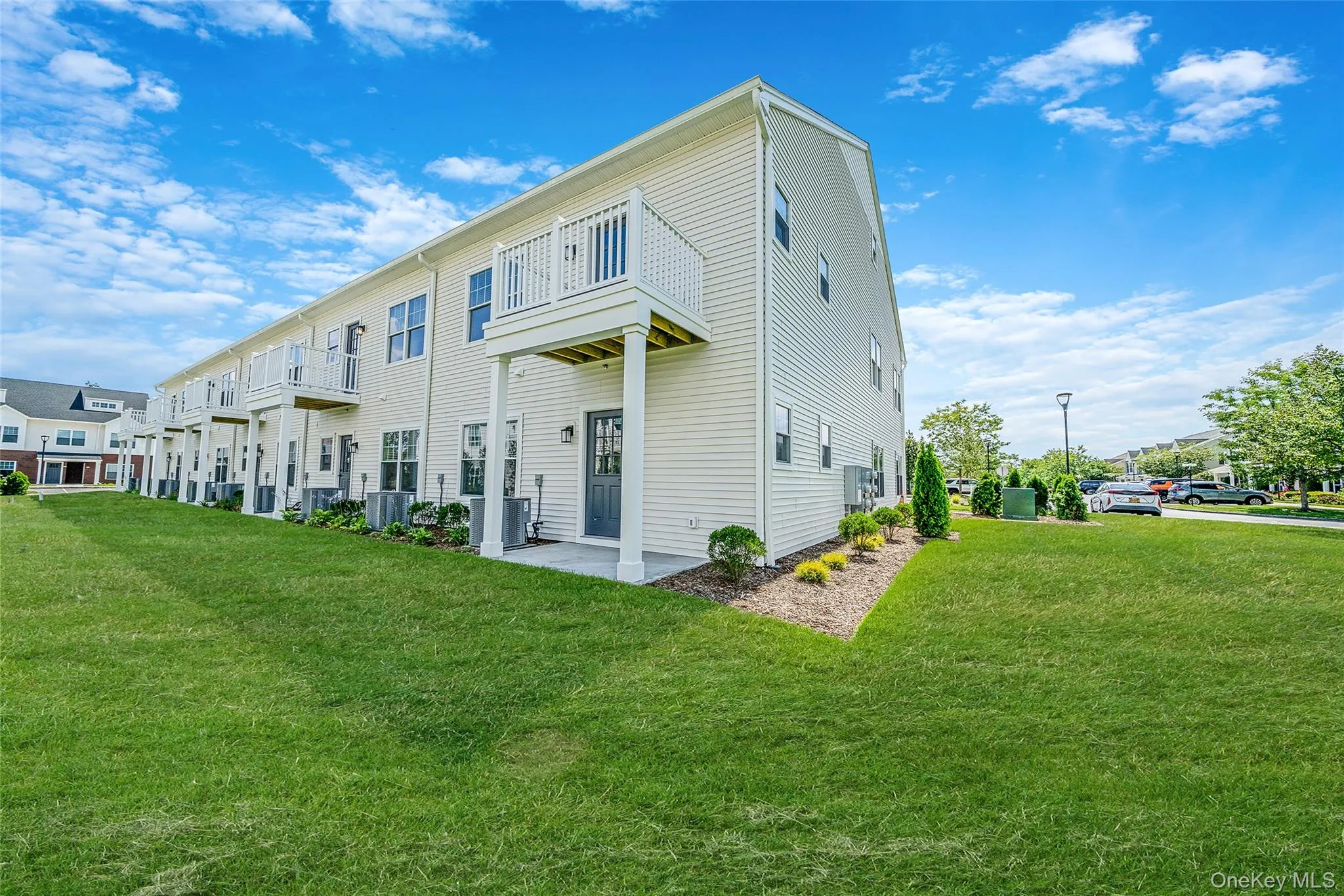 Rear view of property featuring a yard and a balcony Rear view of property featuring a yard and a balcony