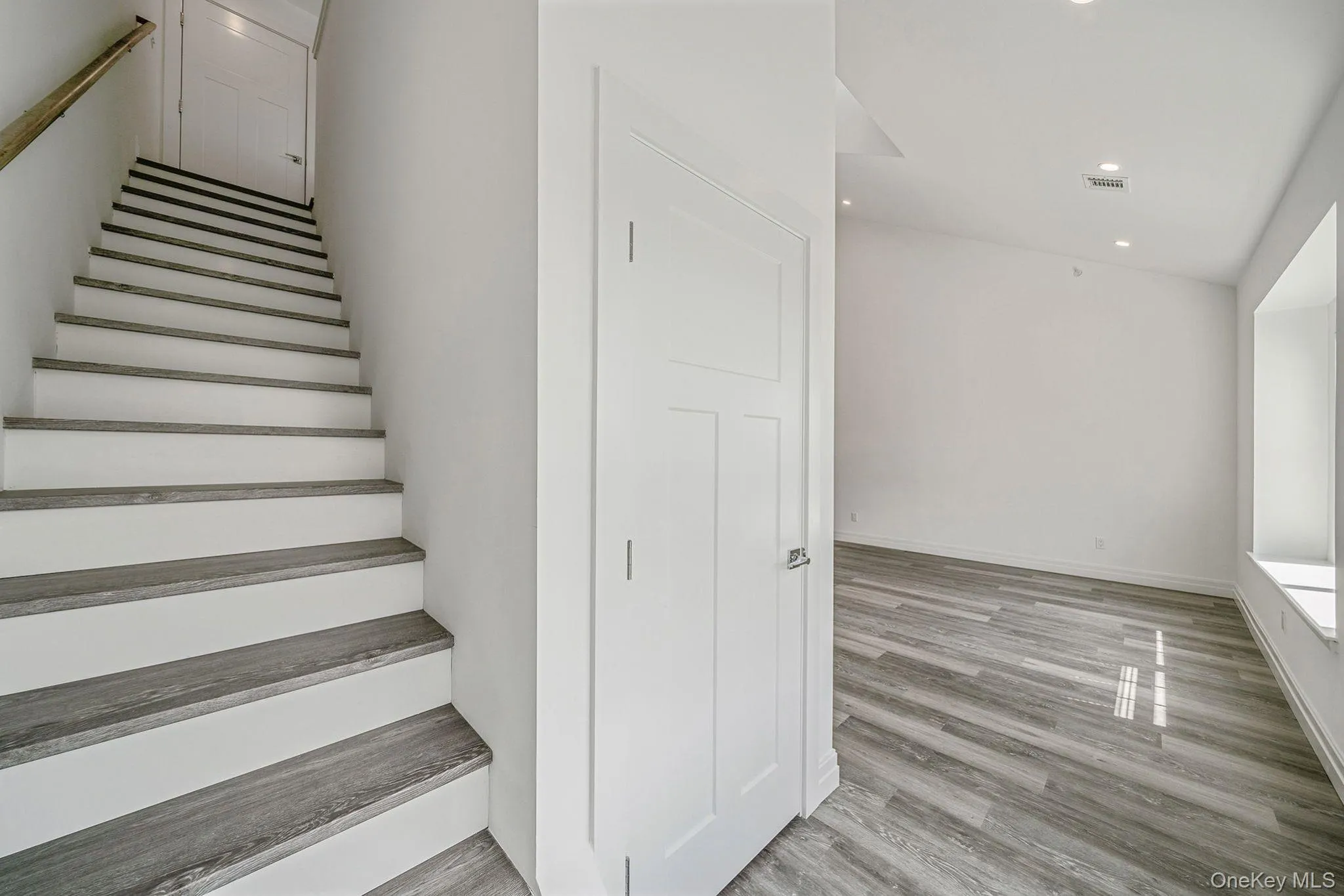 Stairway with recessed lighting and wood finished floors Stairway with recessed lighting and wood finished floors