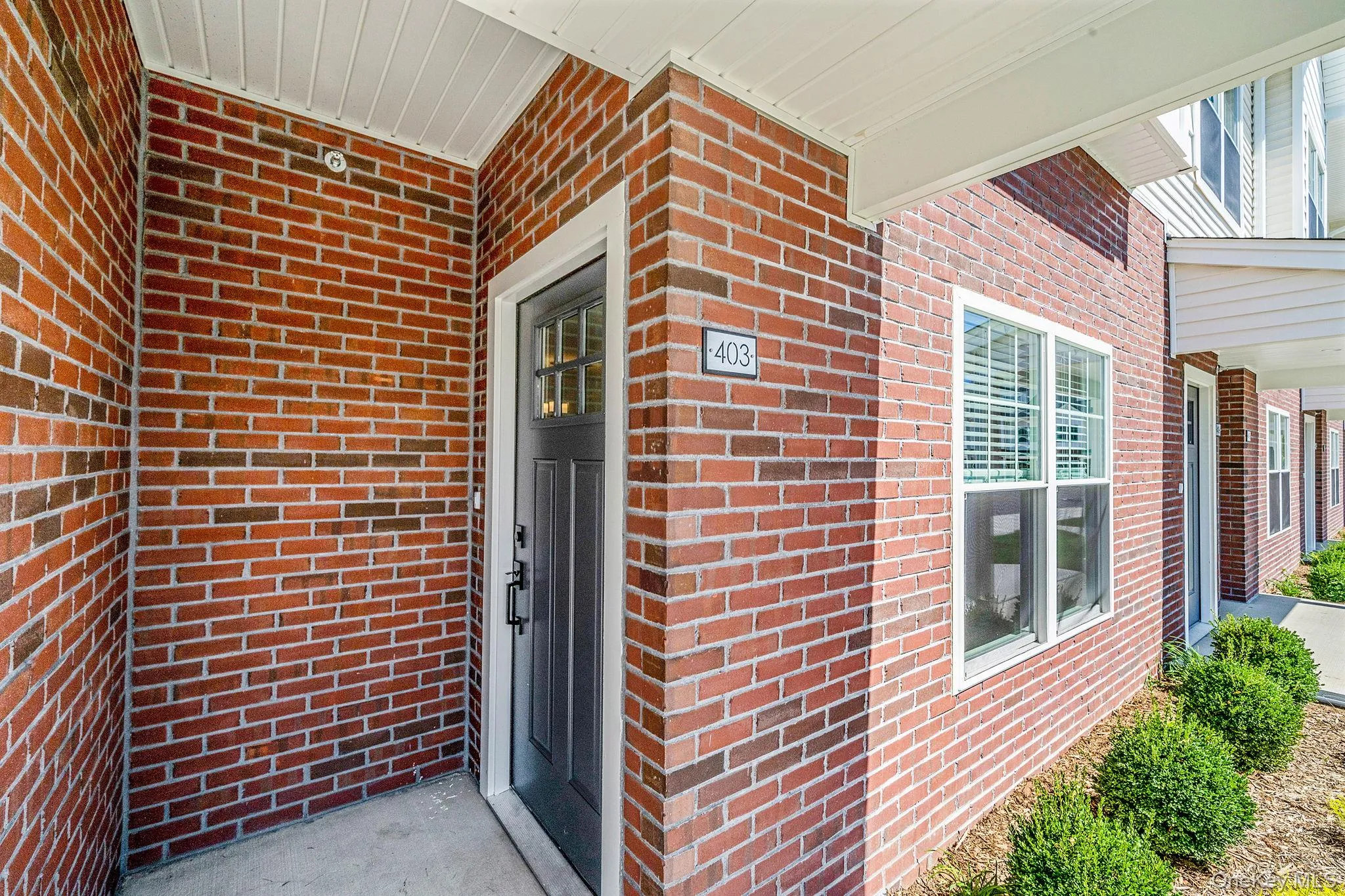 View of exterior entry featuring brick siding and a porch View of exterior entry featuring brick siding and a porch