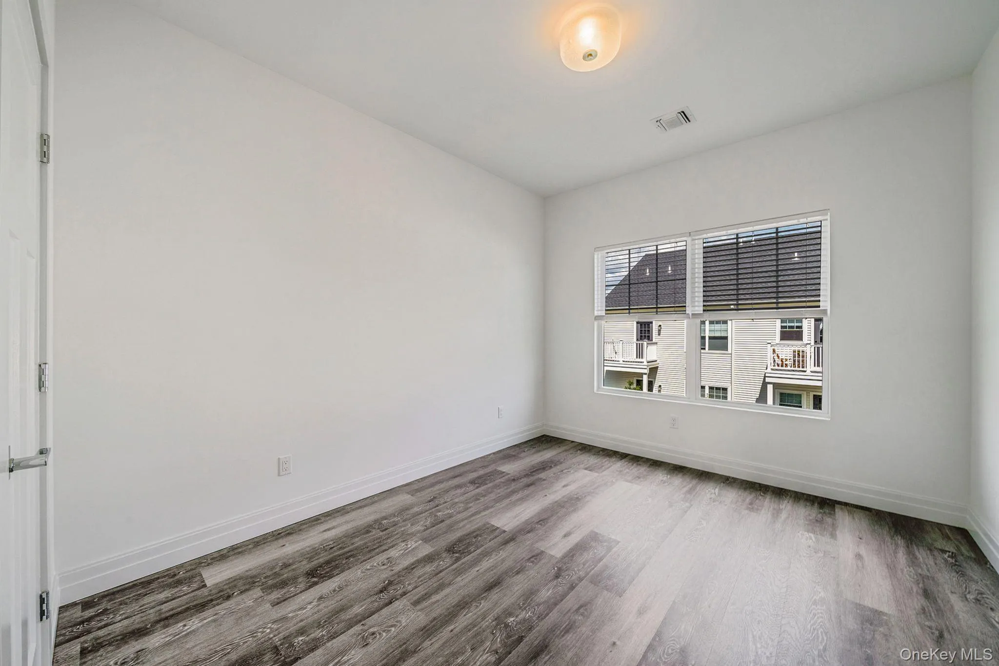 Unfurnished room featuring light wood-type flooring and baseboards Unfurnished room featuring light wood-type flooring and baseboards