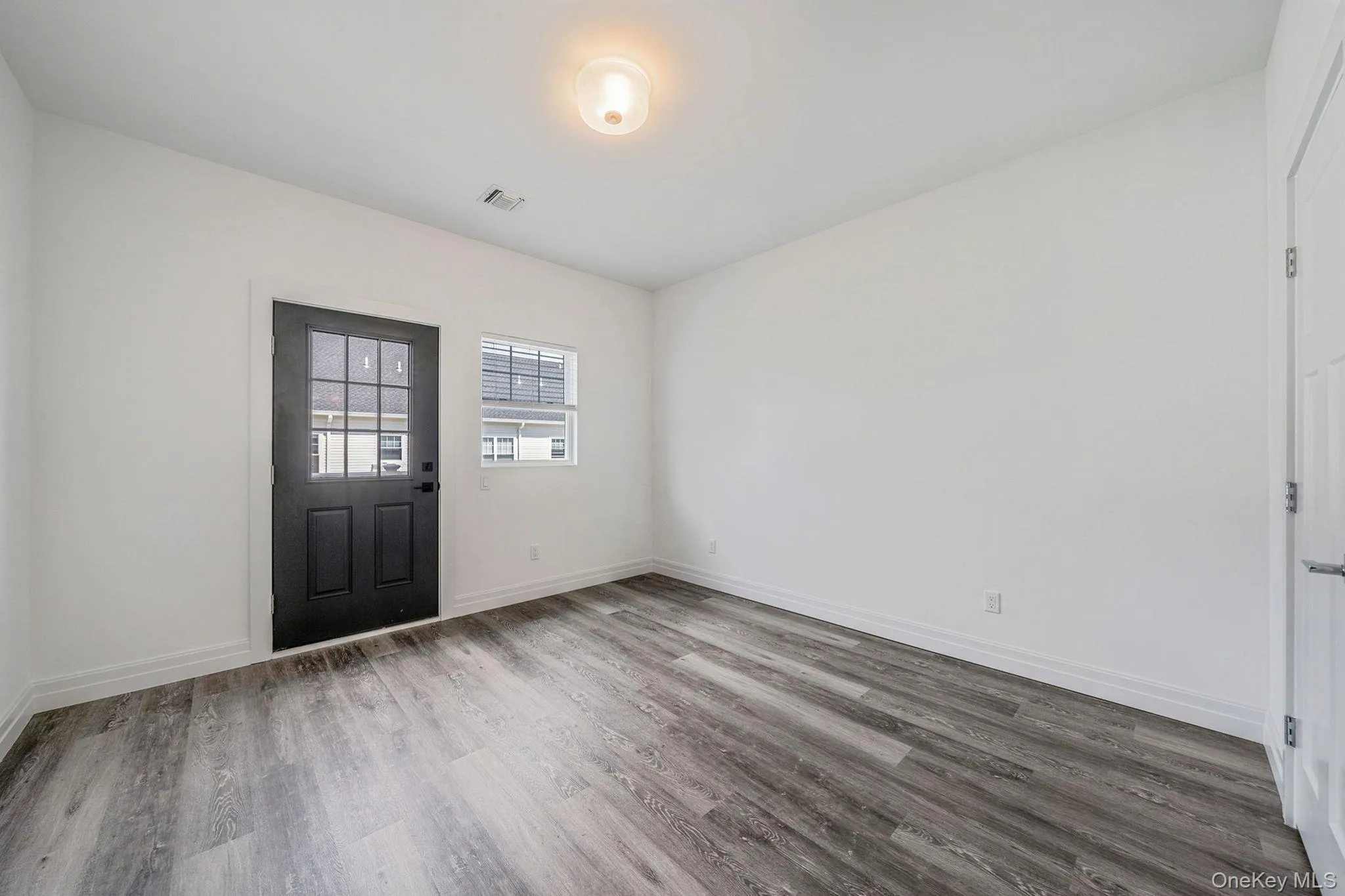 Entryway featuring light wood-type flooring and baseboards Entryway featuring light wood-type flooring and baseboards