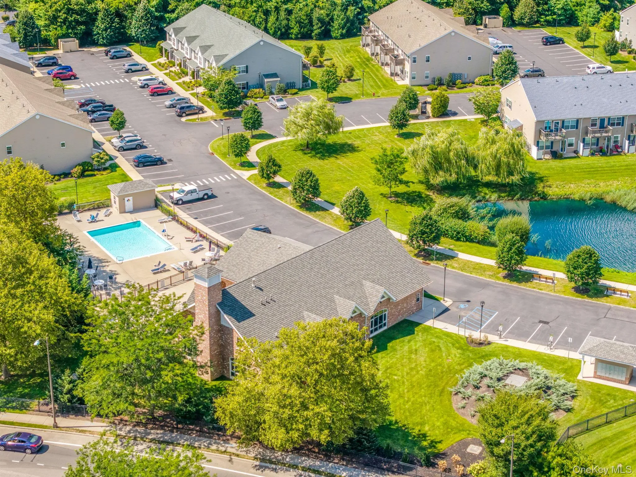 Bird's eye view of a pool area and a large body of water Bird's eye view of a pool area and a large body of water