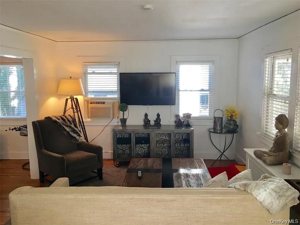 Living room featuring wood finished floors and cooling unit Living room featuring wood finished floors and cooling unit