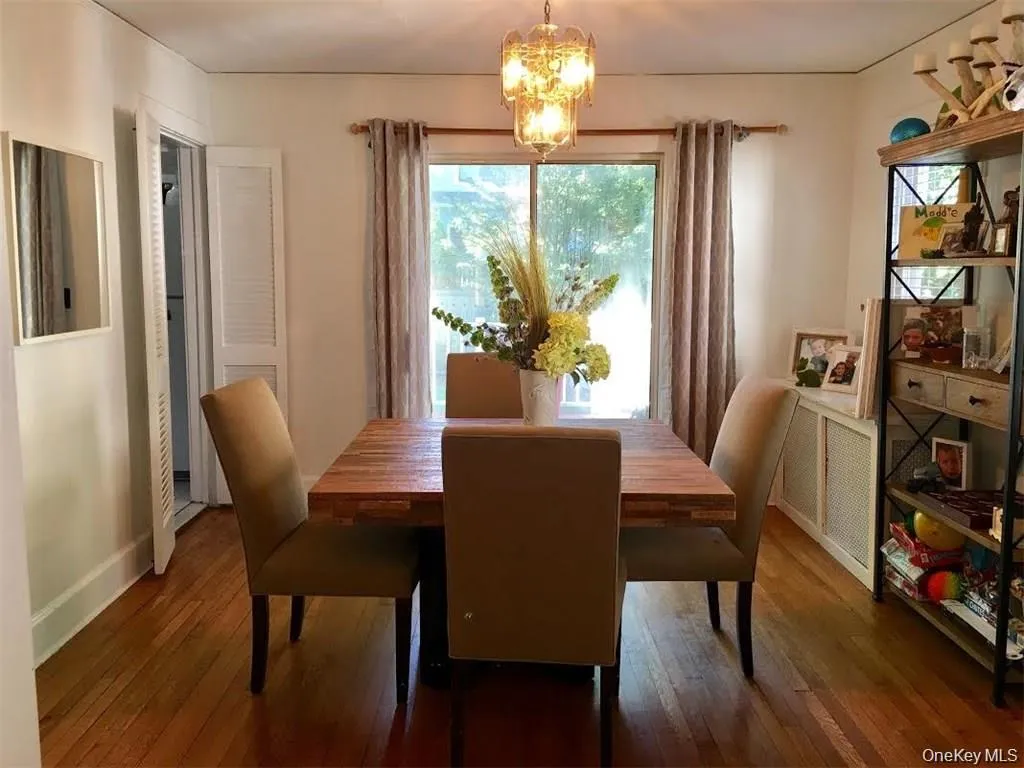 Dining space with dark wood finished floors and a chandelier Dining space with dark wood finished floors and a chandelier