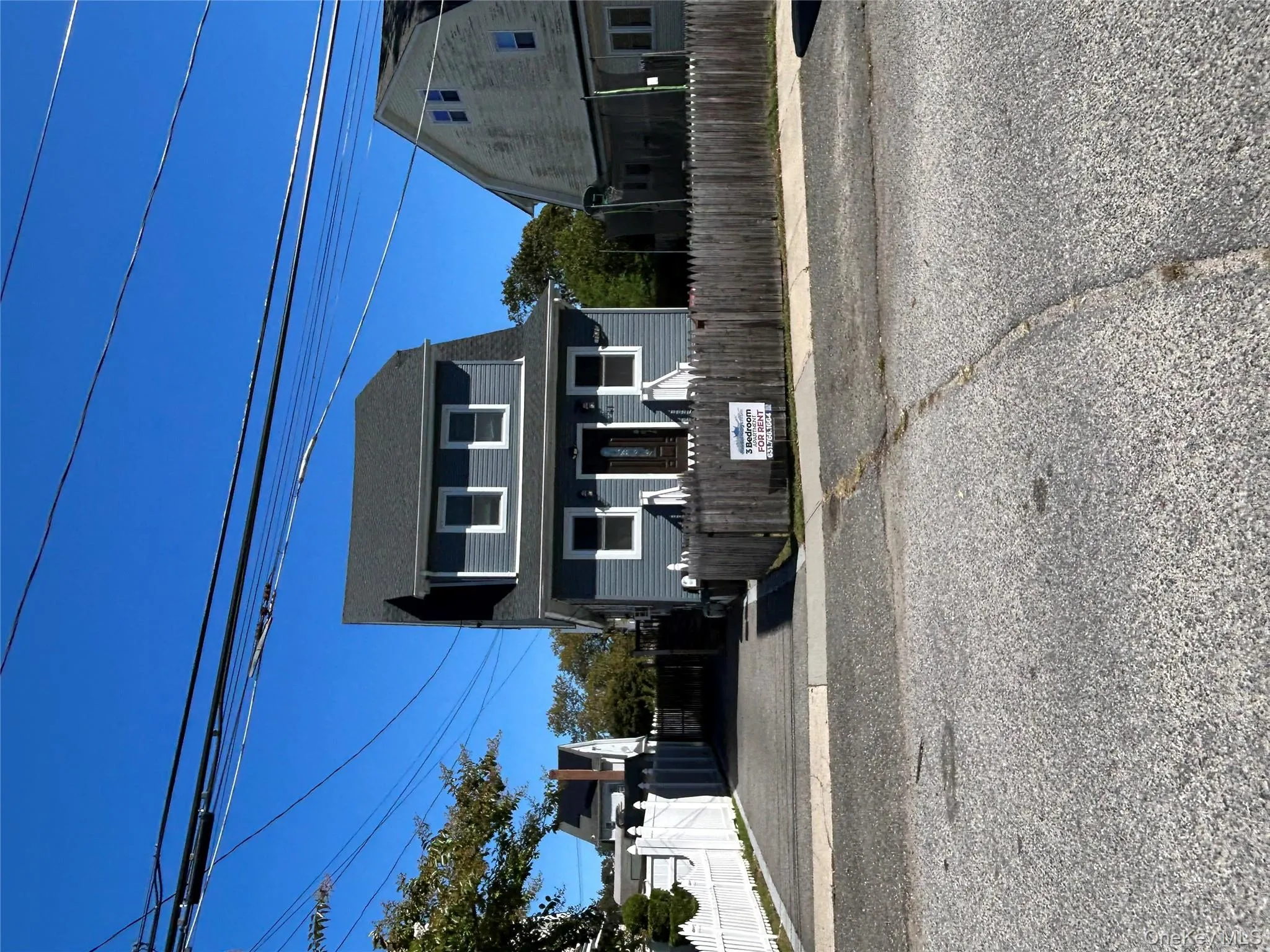 Dutch colonial with a fenced front yard and roof with shingles Dutch colonial with a fenced front yard and roof with shingles