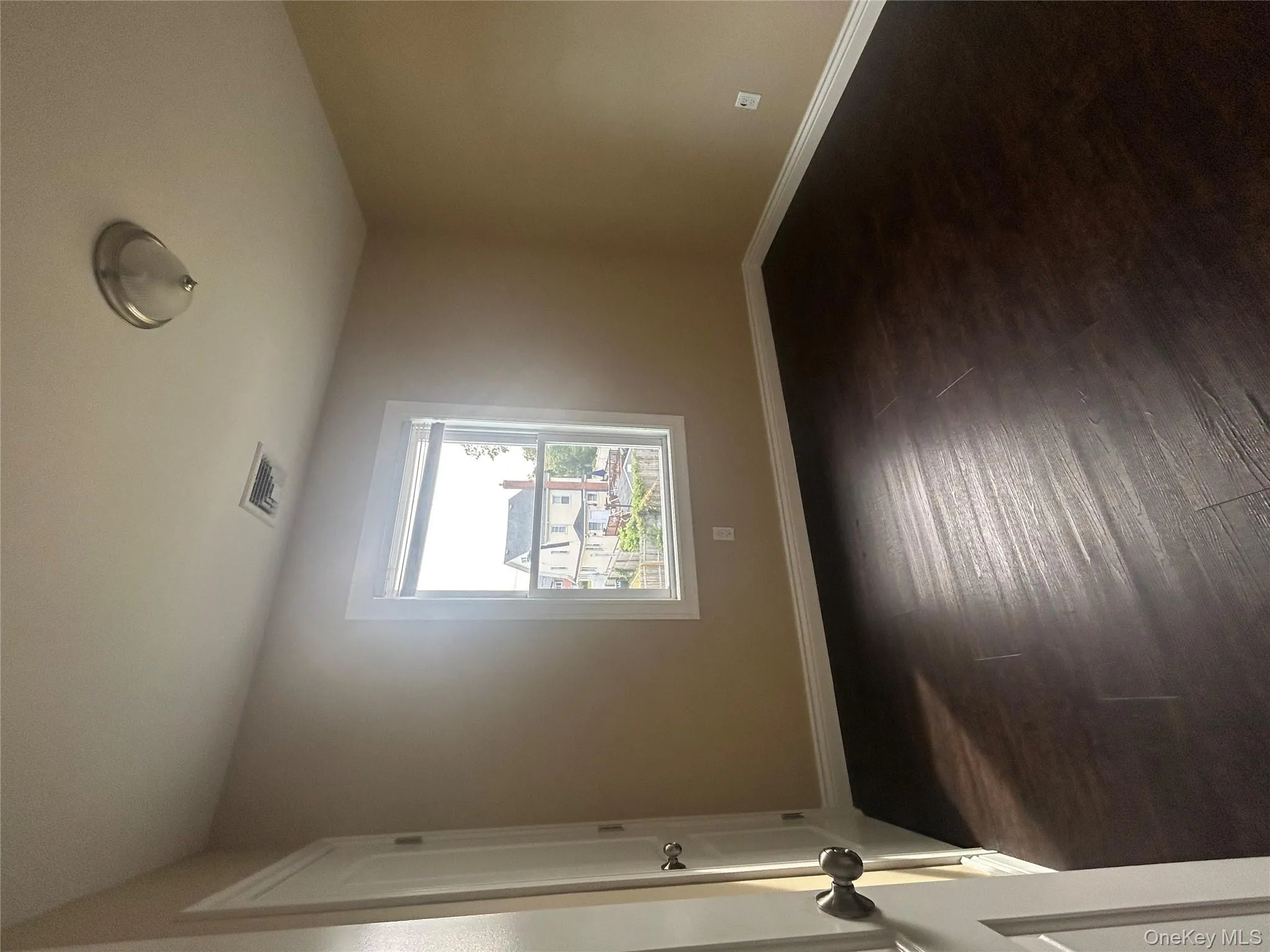 Unfurnished room featuring baseboards and dark wood finished floors Unfurnished room featuring baseboards and dark wood finished floors