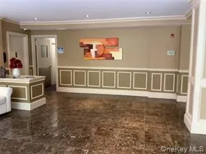 Welcome area with a decorative wall, a wainscoted wall, and ornamental molding Welcome area with a decorative wall, a wainscoted wall, and ornamental molding