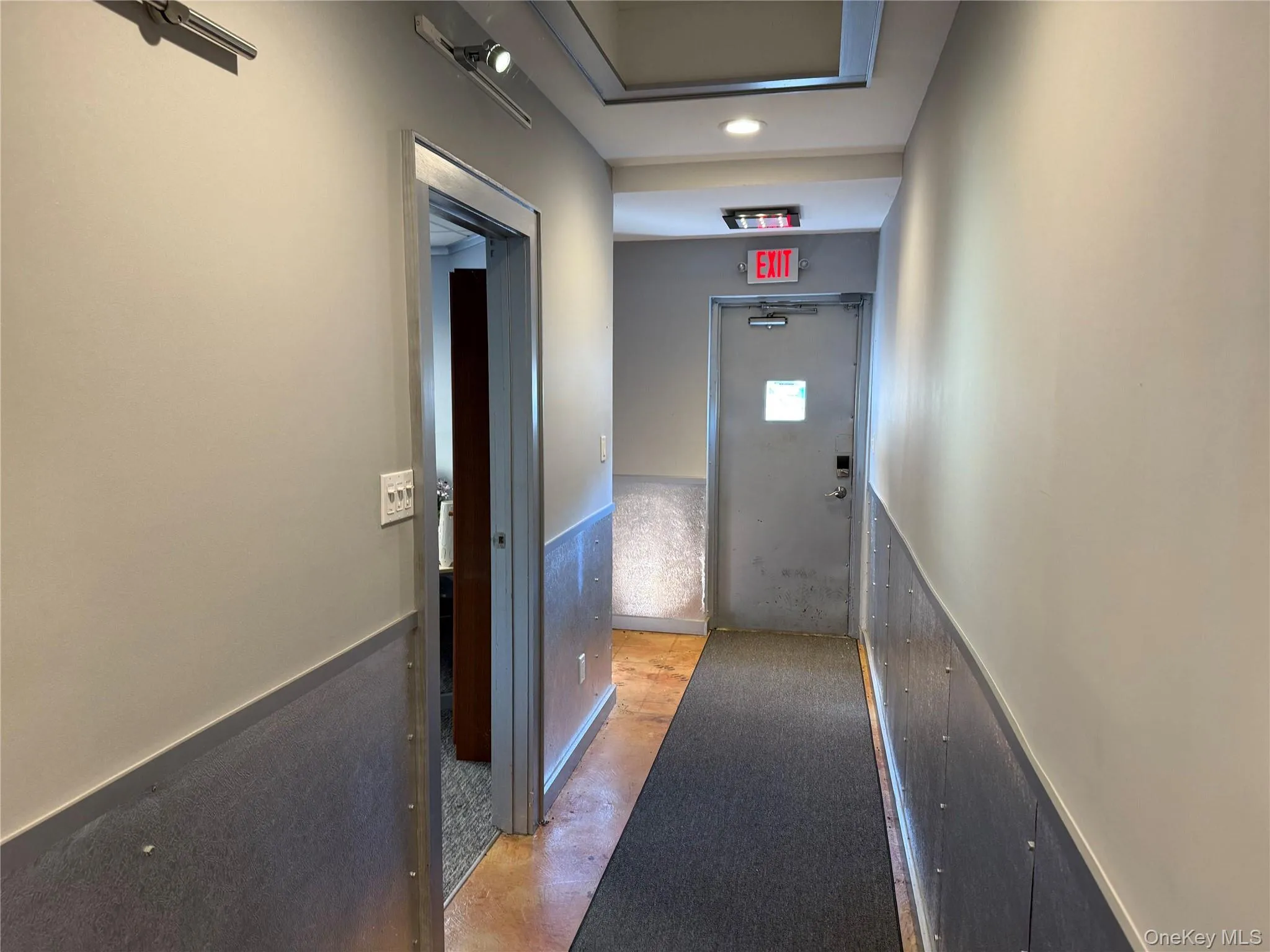 Hallway featuring a wainscoted wall Hallway featuring a wainscoted wall