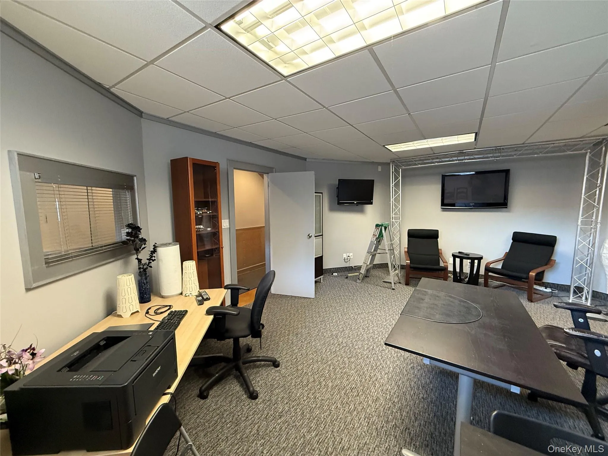 Carpeted office featuring a drop ceiling Carpeted office featuring a drop ceiling