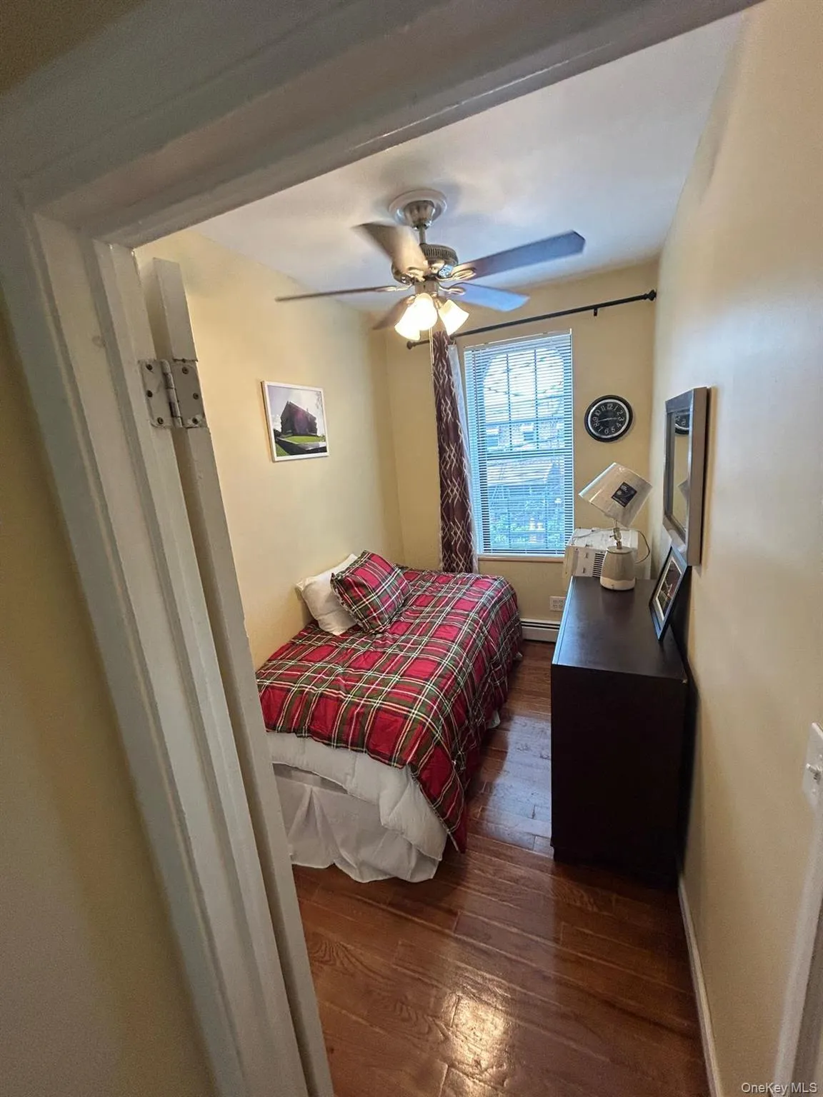 Bedroom featuring dark wood-style flooring and a ceiling fan Bedroom featuring dark wood-style flooring and a ceiling fan
