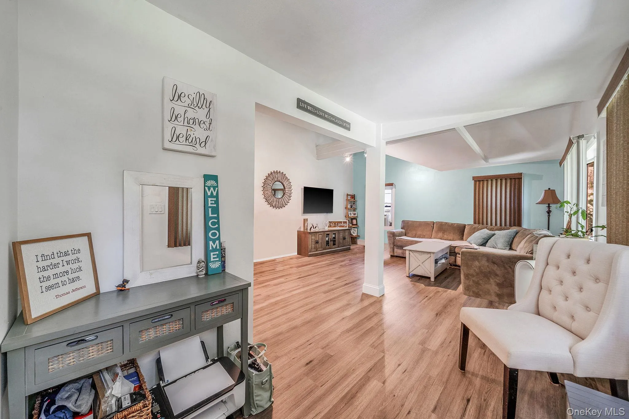Living area featuring light wood finished floors and baseboards Living area featuring light wood finished floors and baseboards
