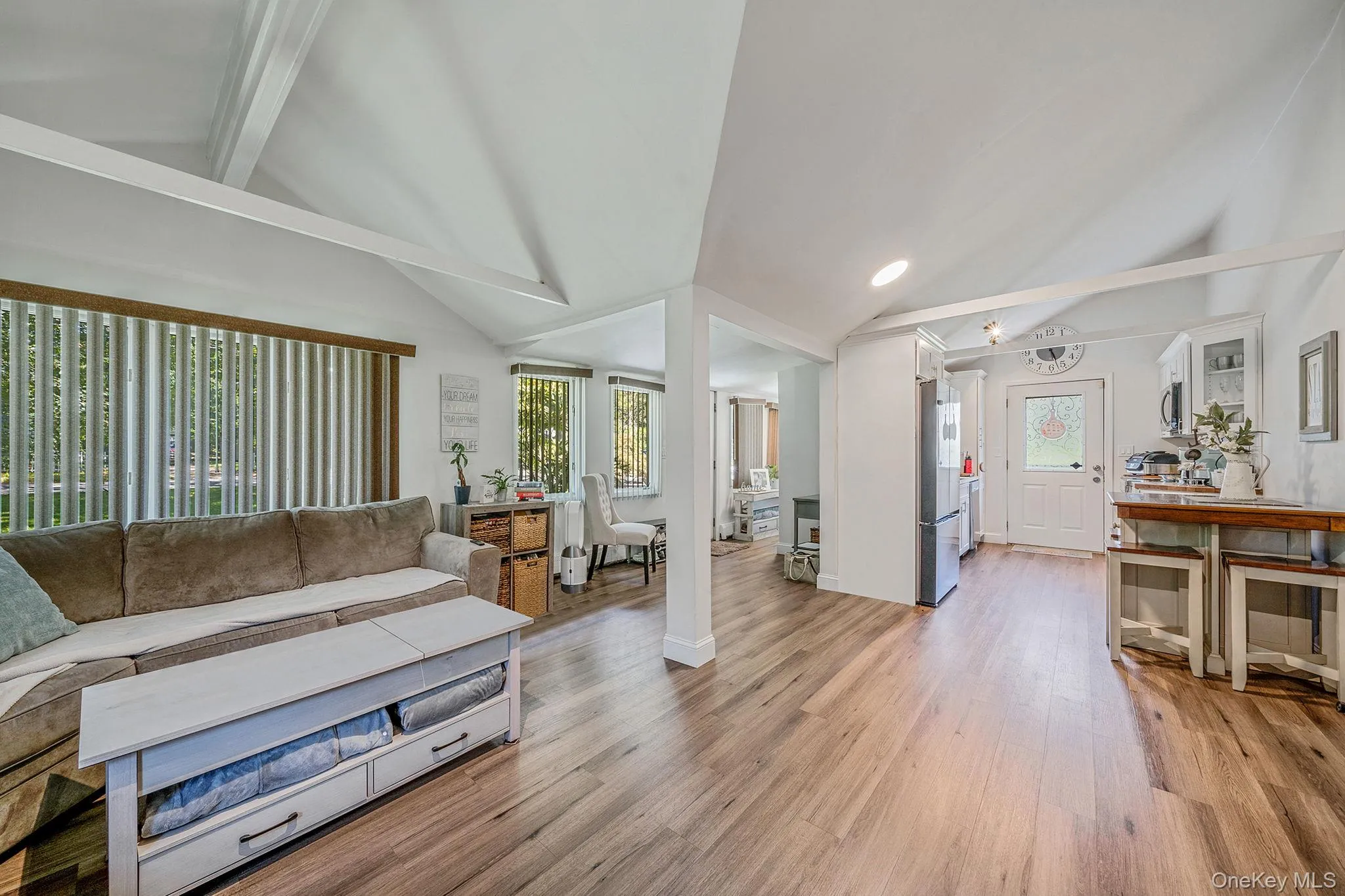 Living area featuring light wood-style flooring, plenty of natural light, and recessed lighting Living area featuring light wood-style flooring, plenty of natural light, and recessed lighting