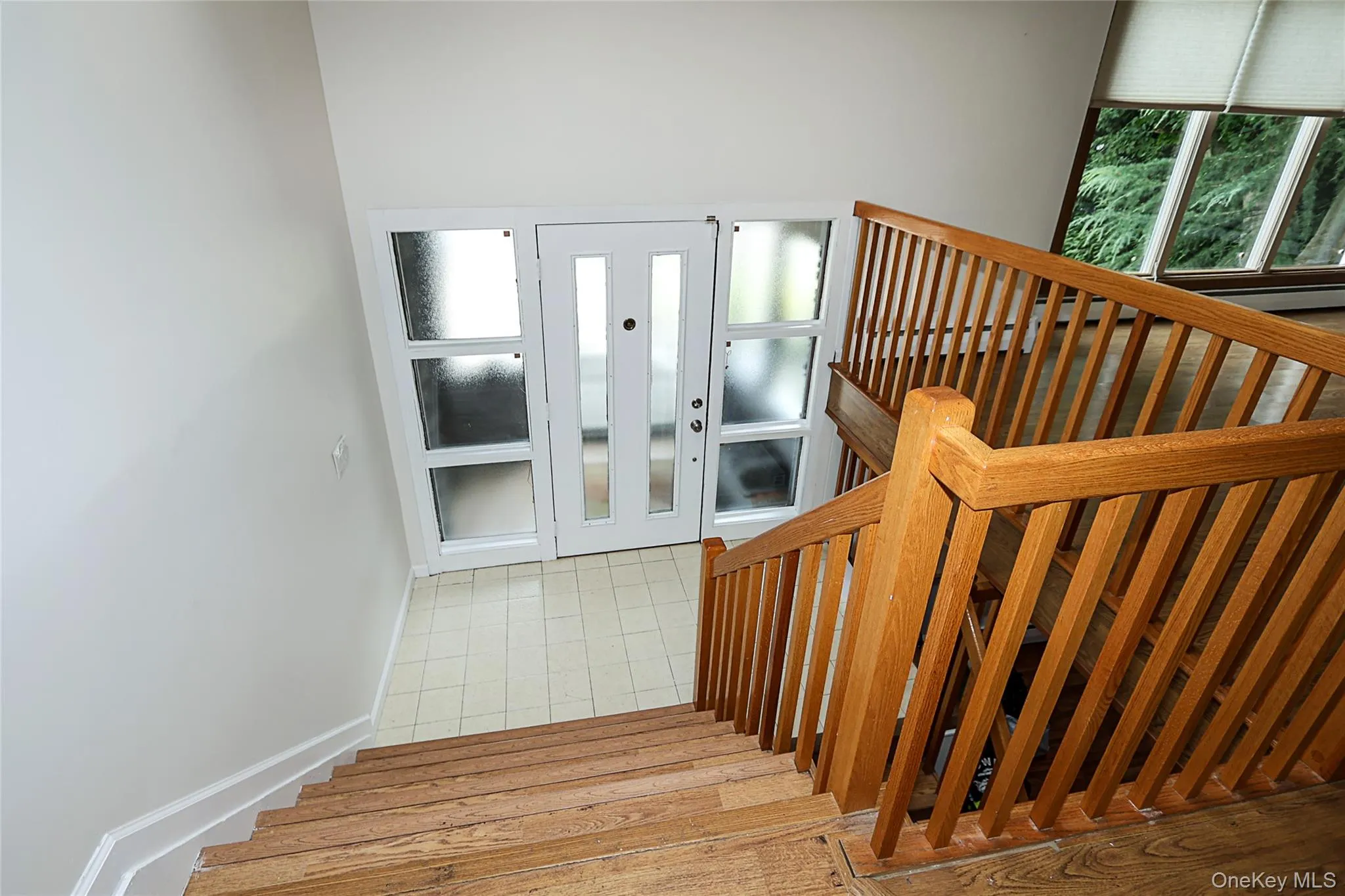 Stairs with baseboards and wood finished floors Stairs with baseboards and wood finished floors