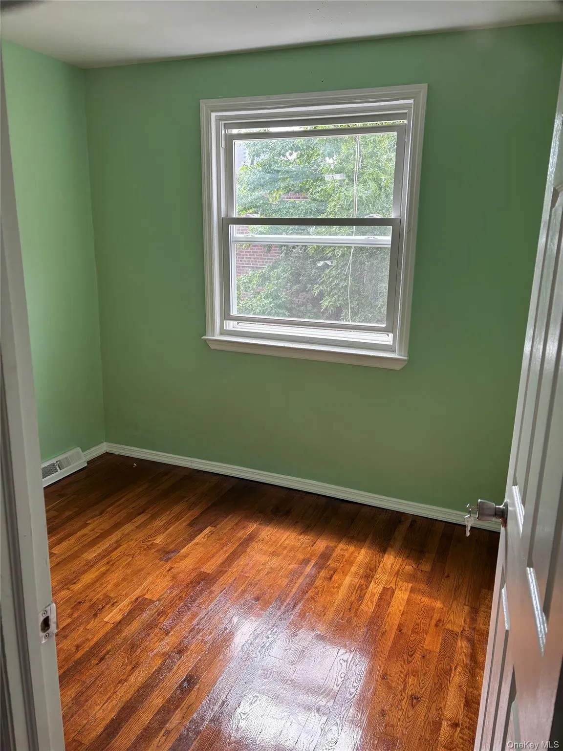 Empty room featuring dark wood-type flooring Empty room featuring dark wood-type flooring