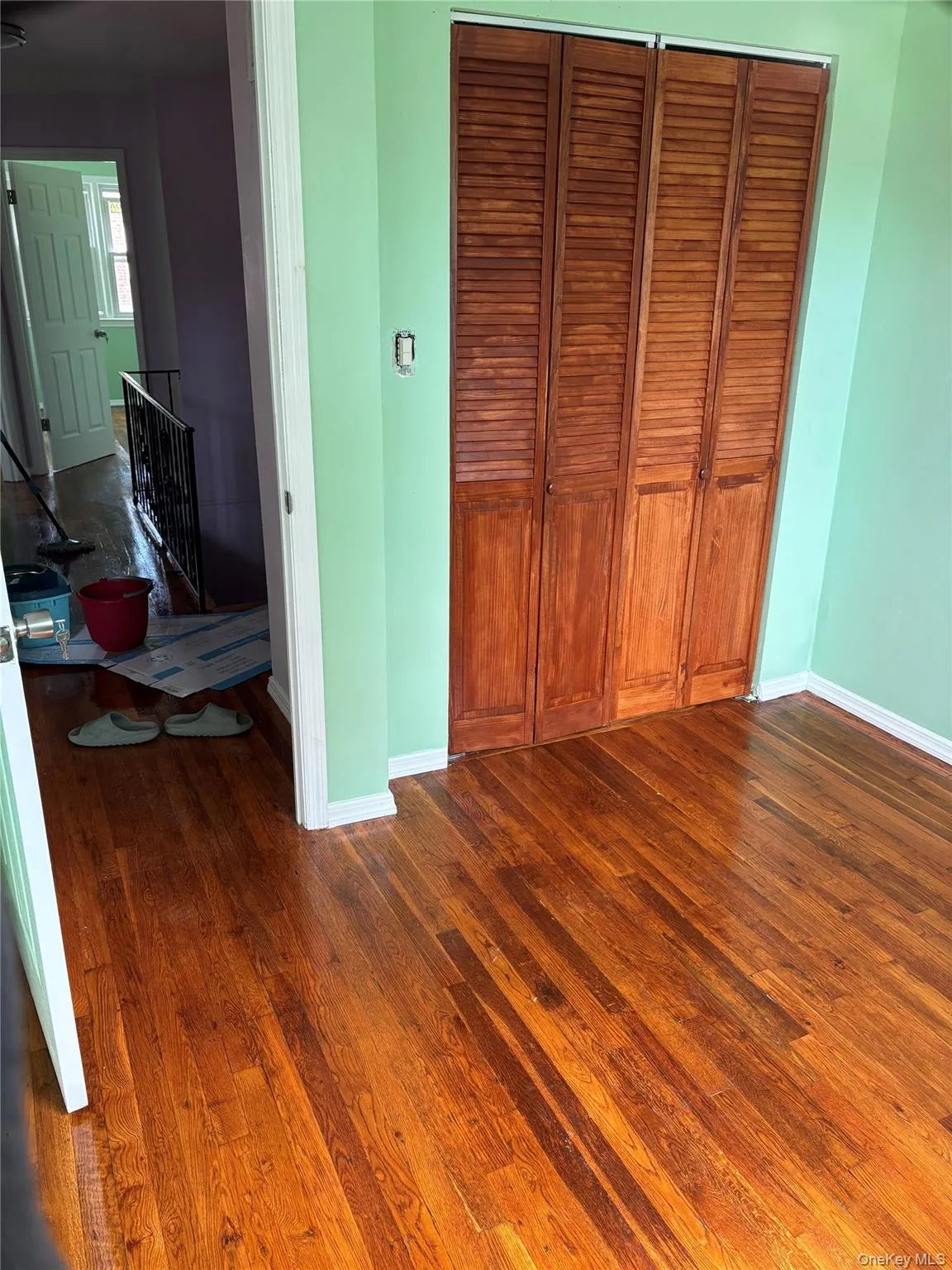 Bedroom with dark wood-style floors and a closet Bedroom with dark wood-style floors and a closet
