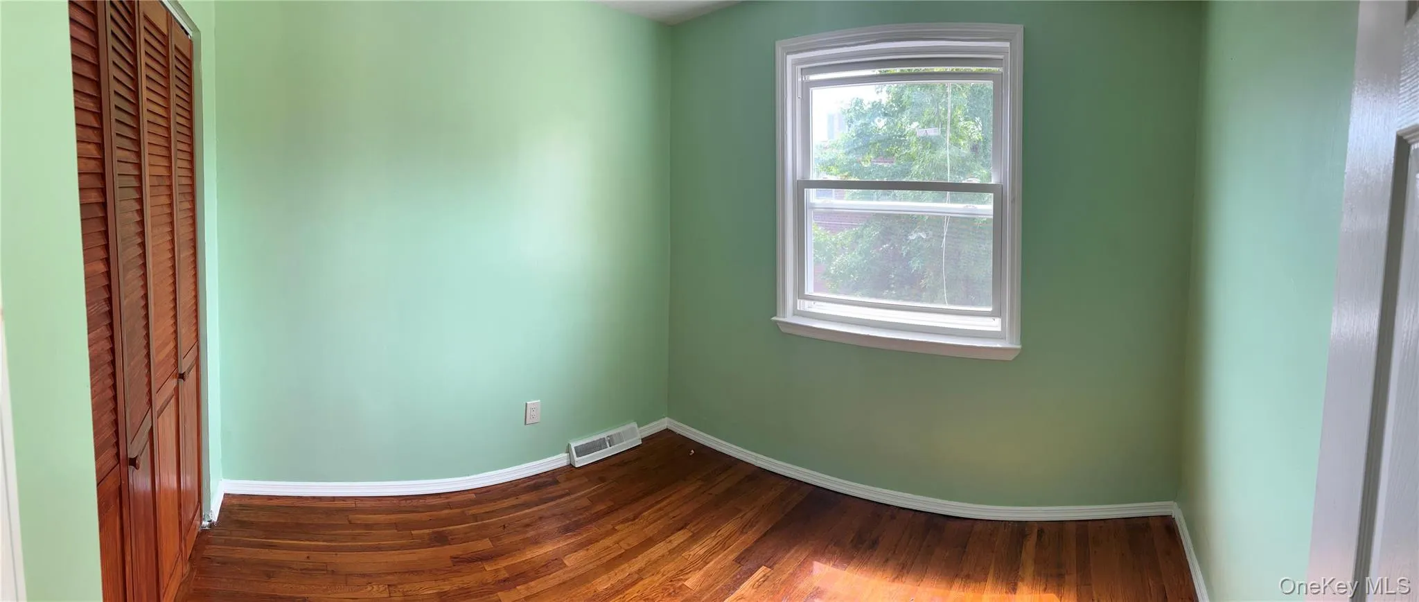 Spare room with baseboards and wood finished floors Spare room with baseboards and wood finished floors