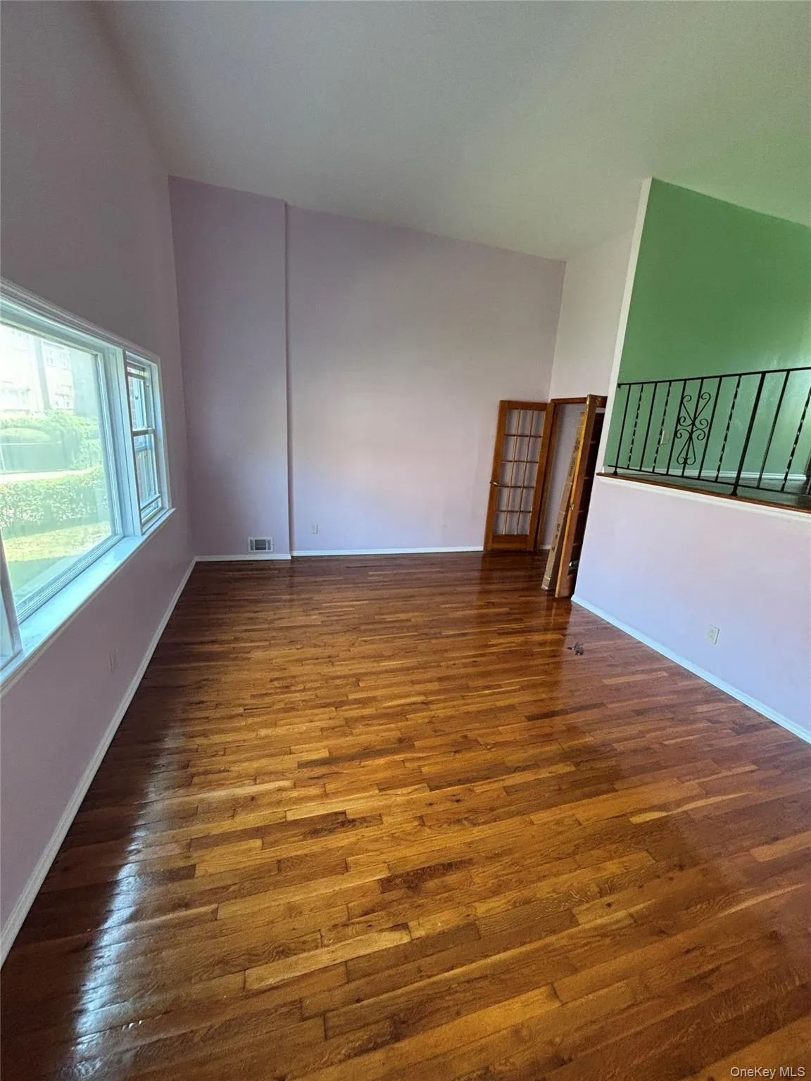Unfurnished room with dark wood-type flooring and baseboards Unfurnished room with dark wood-type flooring and baseboards