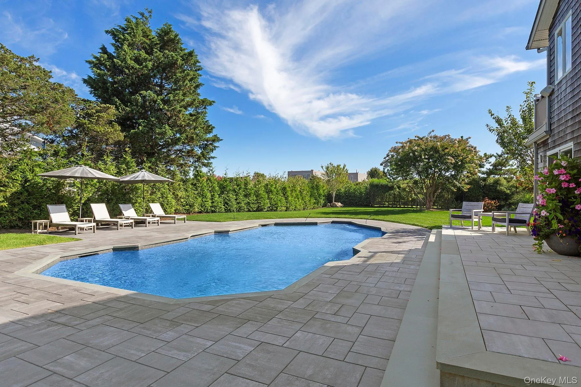 Outdoor pool featuring a patio area and a yard Outdoor pool featuring a patio area and a yard