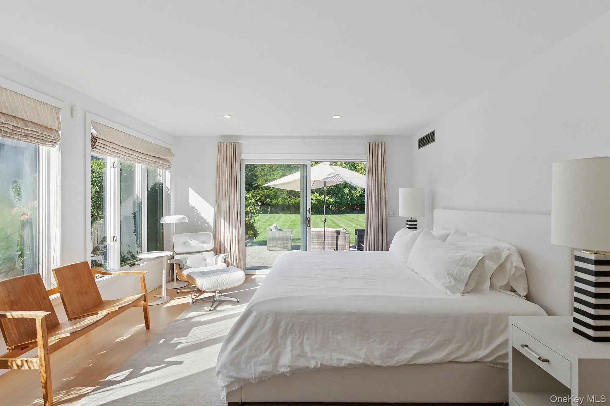 Bedroom with wood finished floors, recessed lighting, and access to outside Bedroom with wood finished floors, recessed lighting, and access to outside